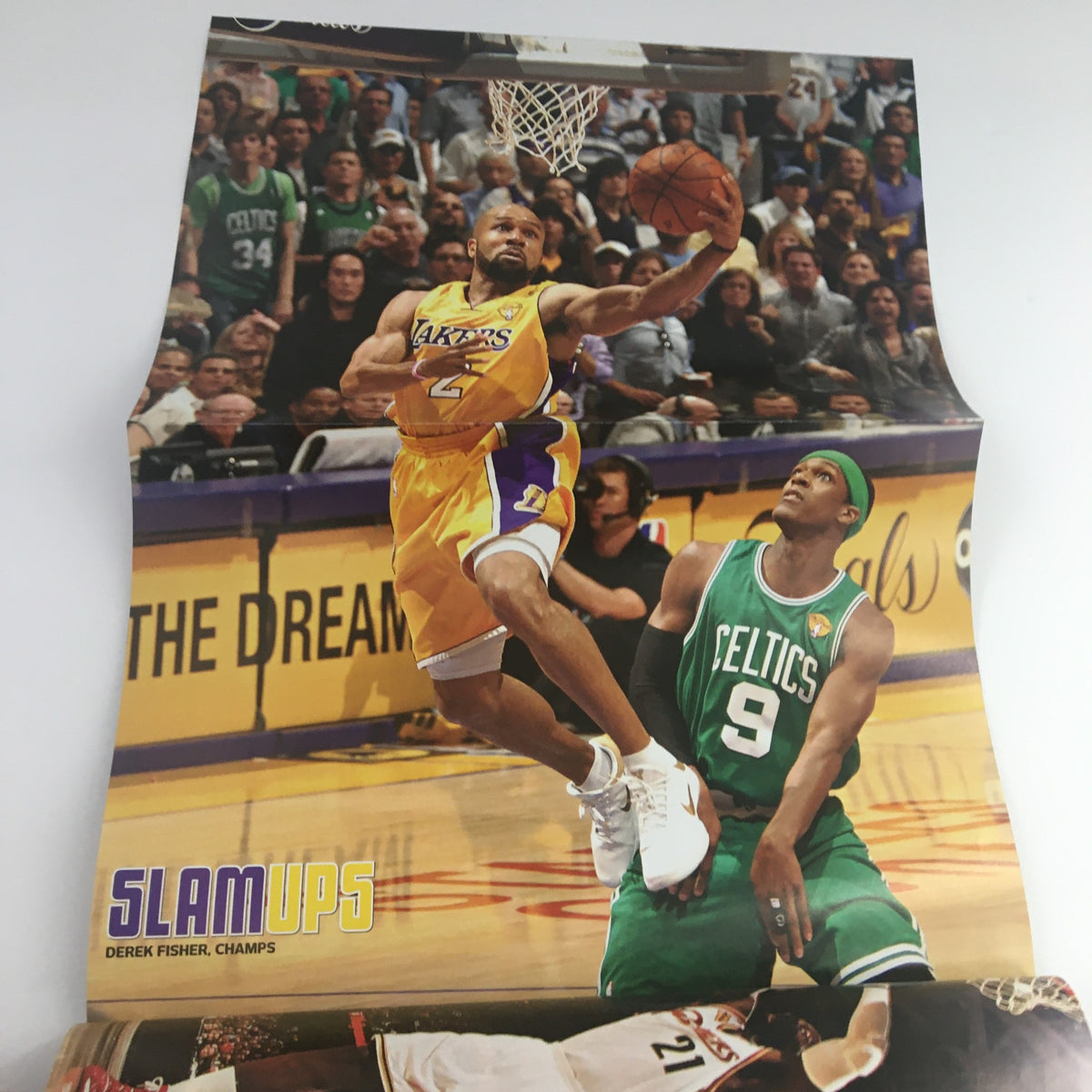 Inside poster of Slam Magazine showcasing Derek Fisher of the Lakers in action, alongside Rajon Rondo of the Celtics, titled 'SLAM UPS' from September 2010 issue.