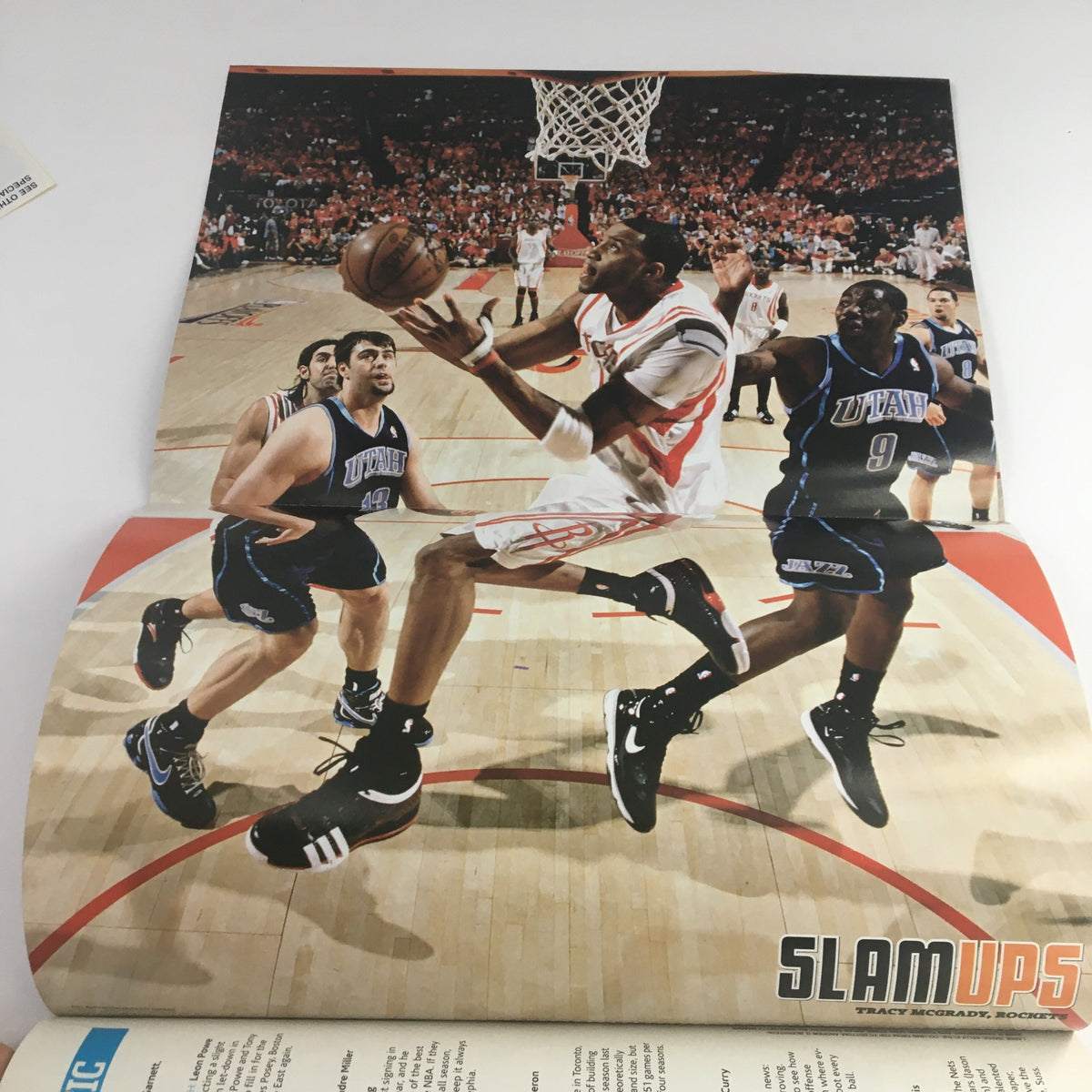 Inside spread of Slam Magazine December 2008 featuring a dynamic action shot of Tracy McGrady in his Houston Rockets uniform, part of the collectible issue with poster.