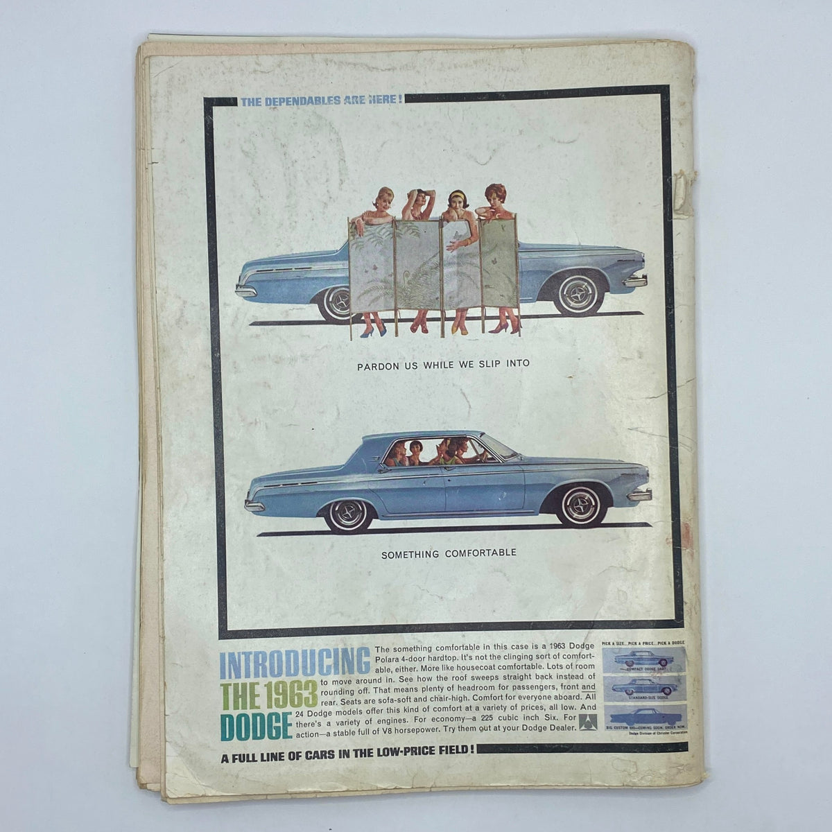 Advertisment on the back cover of Playboy Magazine December 1962 featuring a 1963 Dodge car and playful models.