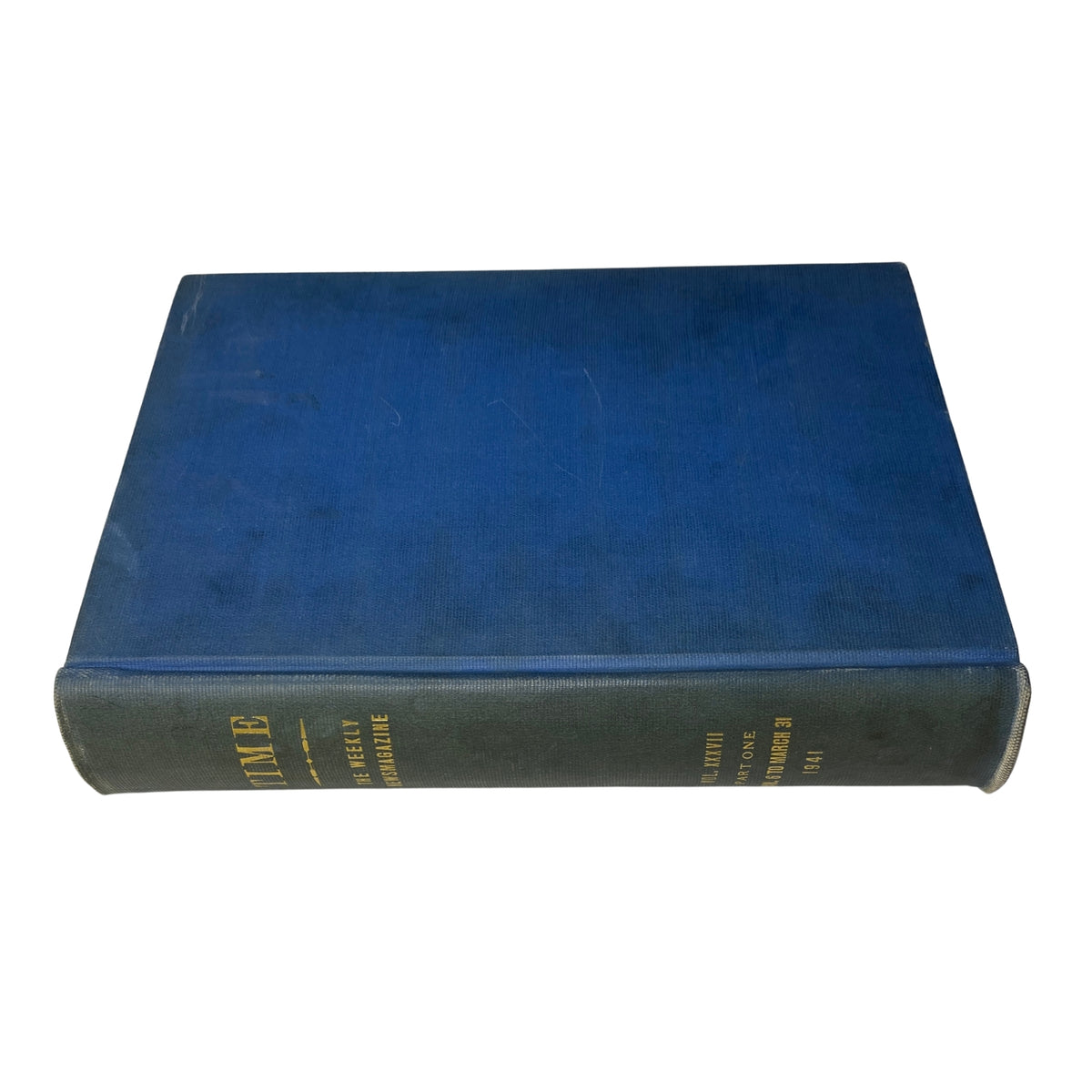 Side view of a library bound edition of Time Magazine with a blue cover, showcasing its sturdy spine and gold lettering for archival purposes.