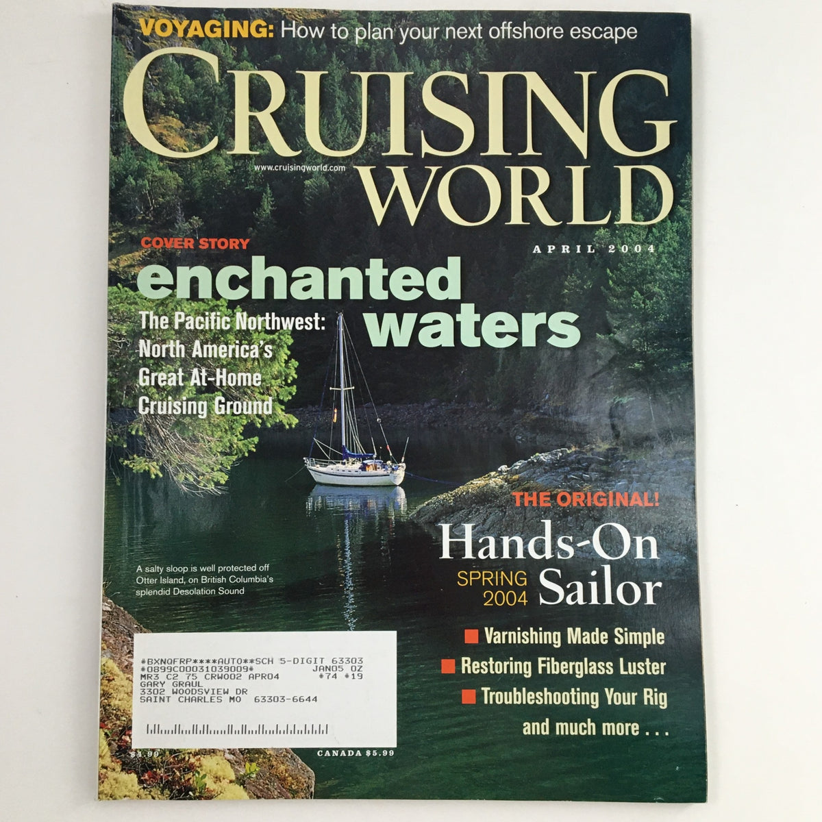 Cruising World Magazine April 2004 cover featuring the article 'The Pacific Northwest Enchanted Waters', showcasing a scenic image of a sailboat in a lush green landscape with text highlighting the magazine's features.