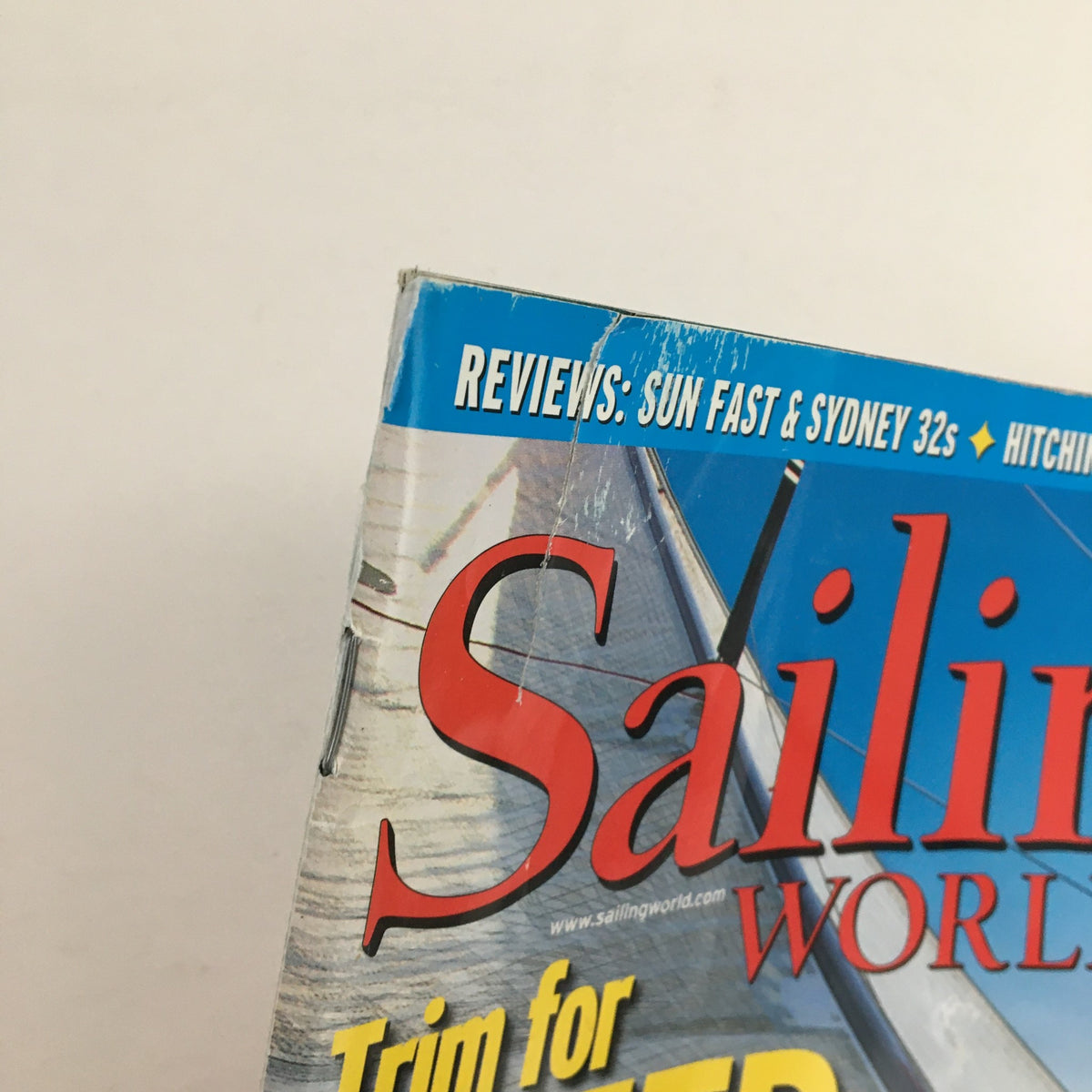 Close-up of the top corner of Sailing World Magazine May 2003, with the title 'Sailing World' and 'Trim for Speed' visible, highlighting the magazine's focus on sailing reviews and technology.