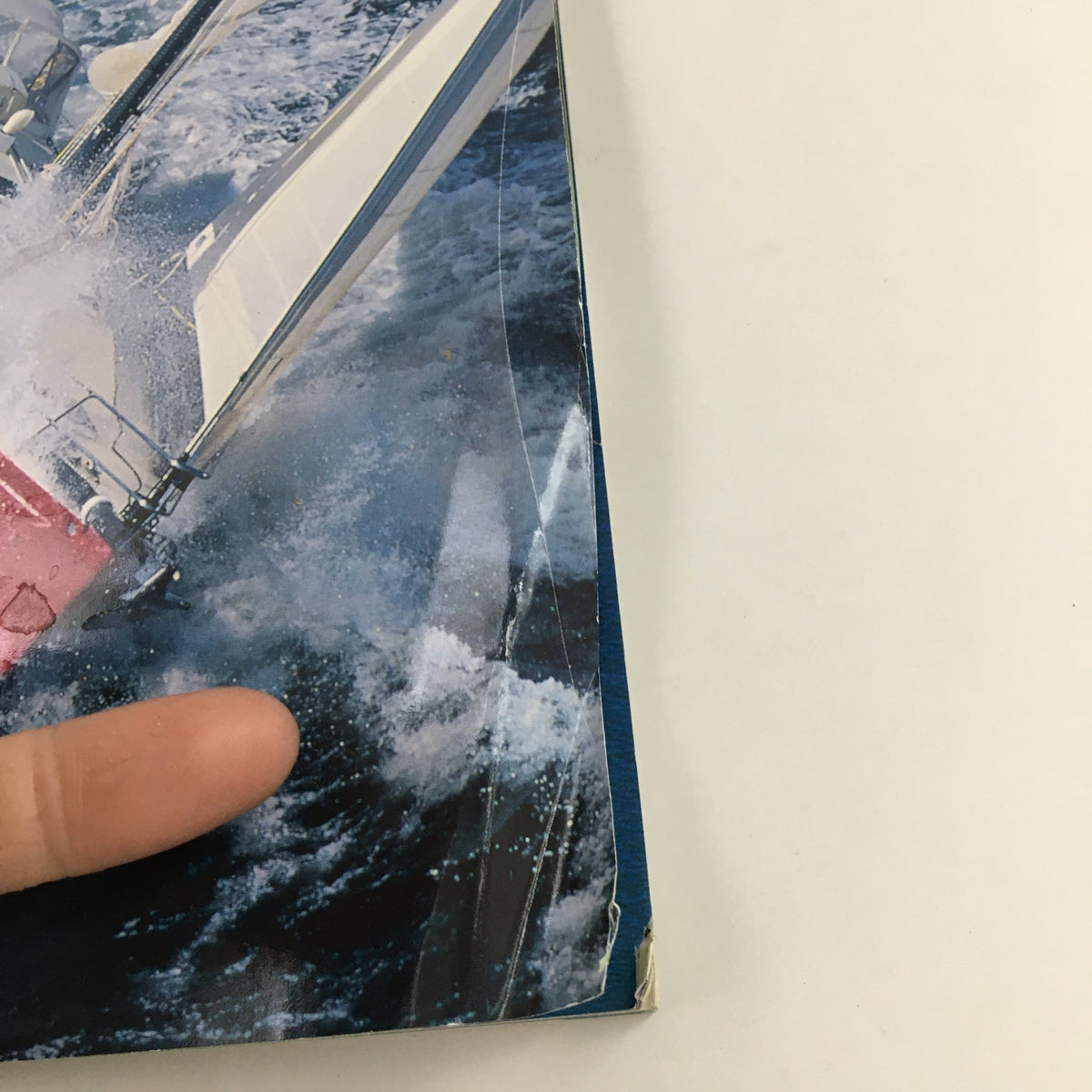 Close-up detail of Cruising World Magazine June 2004, displaying the sail and waves from the iconic cover 'Cruiser Quadrille at The Narraganset Bay Water', showcasing maritime adventure.