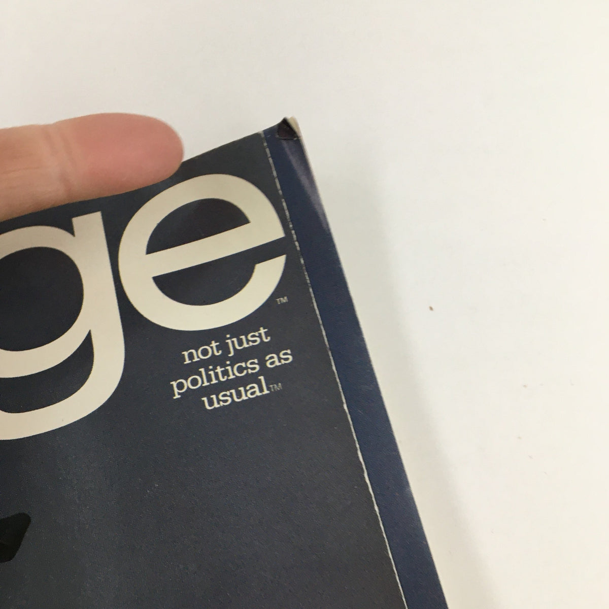 Close-up view of the cover corner of George Magazine October 1995, features branding and tagline 'not just politics as usual'.