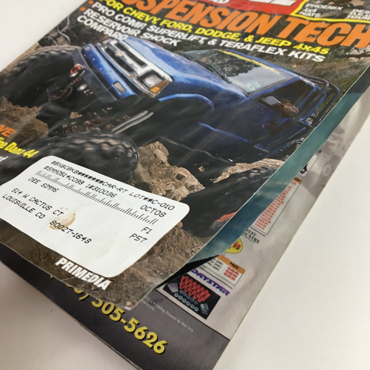 Side view of Petersen's 4 Wheel & Off-Road Magazine June 2004 showing the spine and address label, emphasizing its collectible nature and vintage character related to Suspension Tech for Chevy, Ford, Dodge, and Jeep 4x4s.