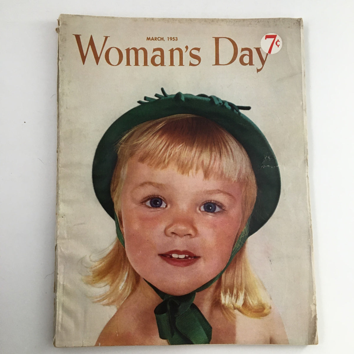 Cover of Woman's Day Magazine March 1953 featuring a young girl in a green hat, showcasing the magazine's nostalgic appeal.