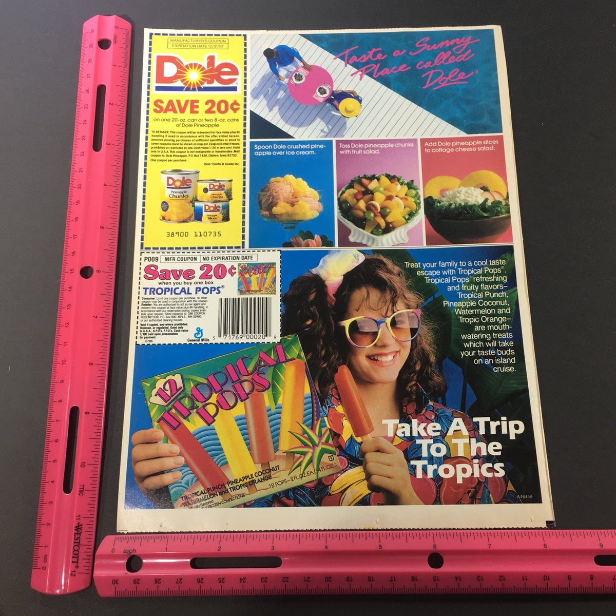 VTG Retro 1986 Hershey's Syrup FREE T-Shirt along with a Dole Pineapple print advertisement featuring colorful fruit dishes and a retro design, showcasing a fun vibe from the 1980s.