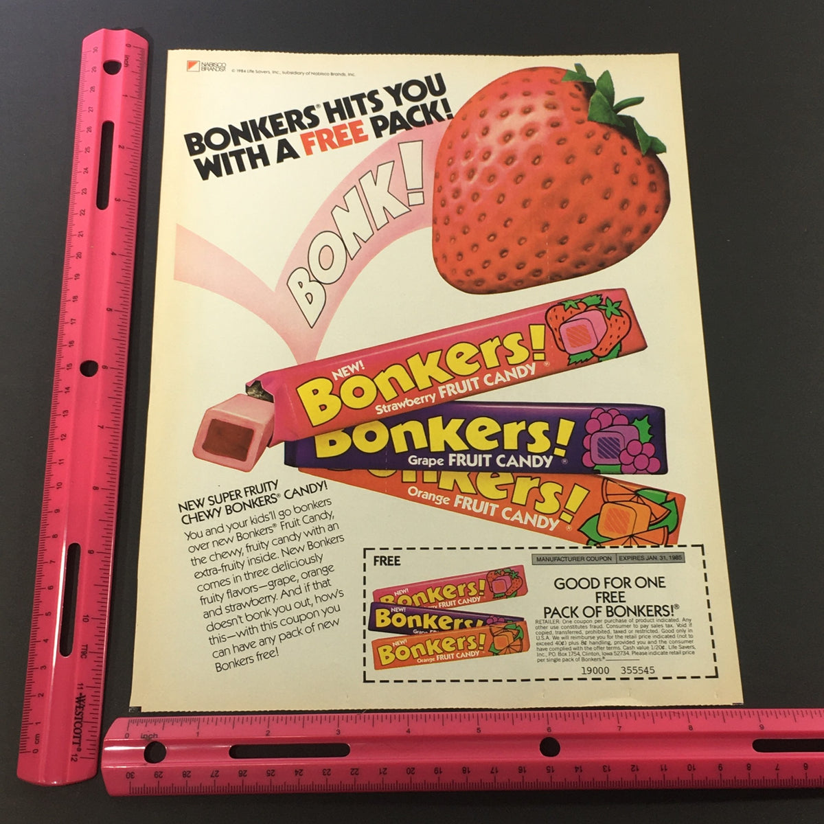 VTG Retro 1985 Bonkers Super Fruity Chewy Candy Print Ad showcasing colorful candy bars with a strawberry and promotional text for a free pack offer.