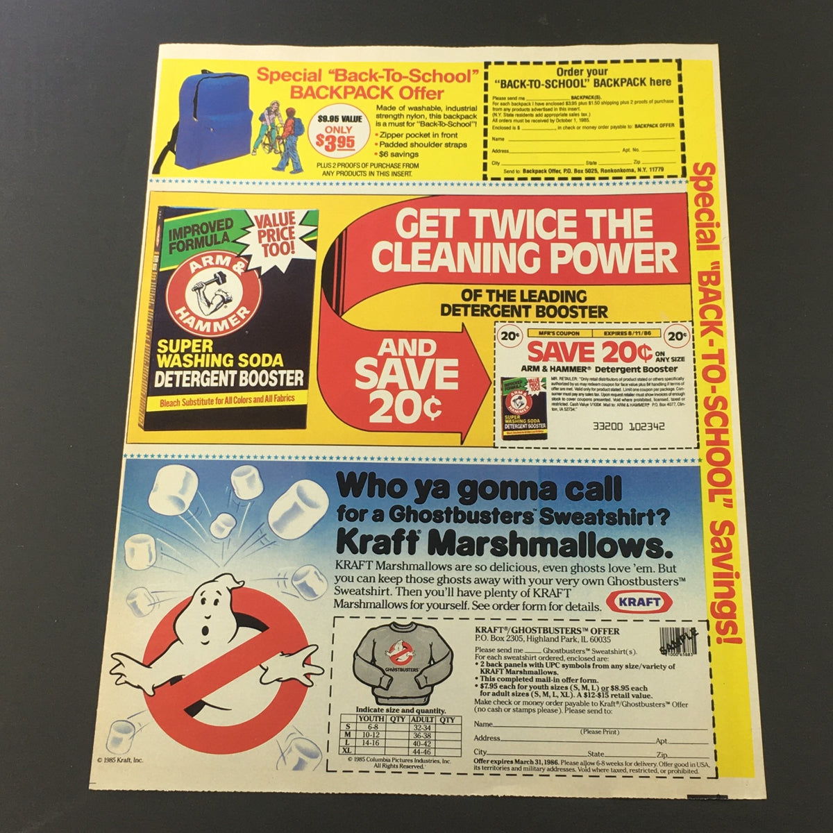 Vintage 1986 advertisement featuring Arm & Hammer soda detergent and Ghostbusters sweatshirt coupon. The ad highlights cleaning power and a special backpack offer for school, with branding elements from both products.