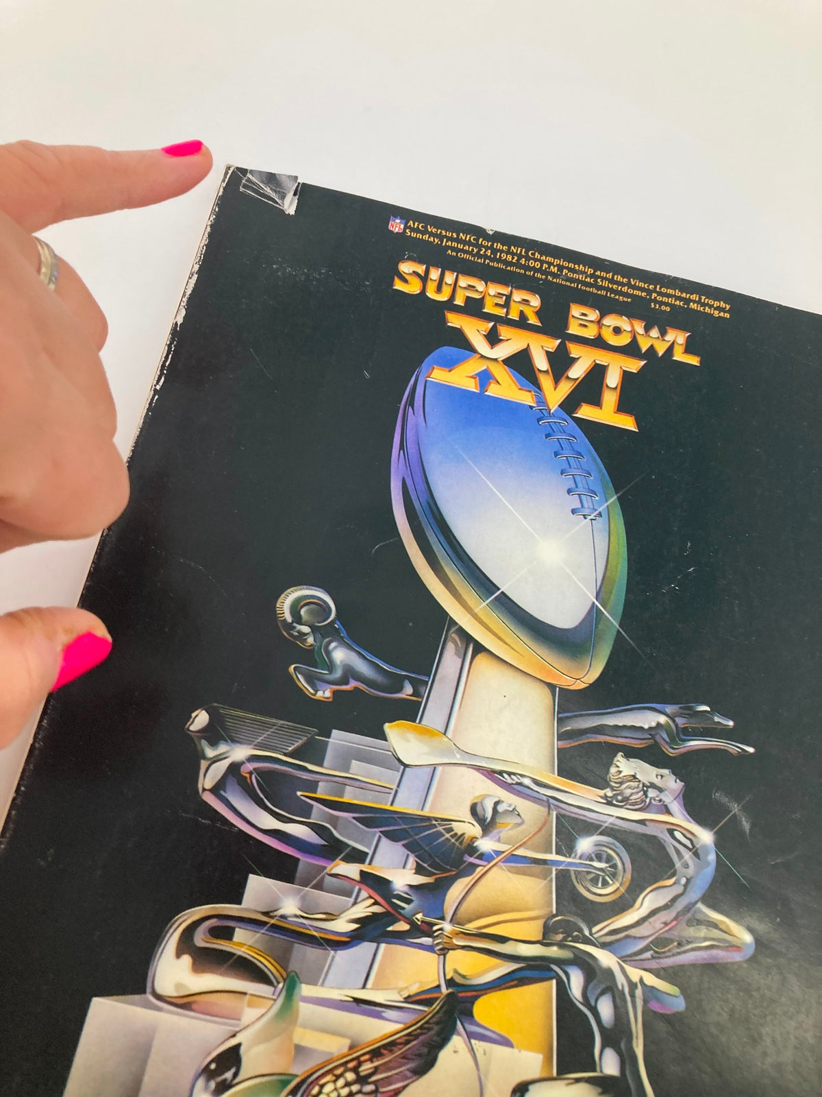 Close-up of the cover of the January 24, 1982 NFL Superpro Club Super Bowl XVI Magazine showing a corner detail and artwork of the Vince Lombardi Trophy.