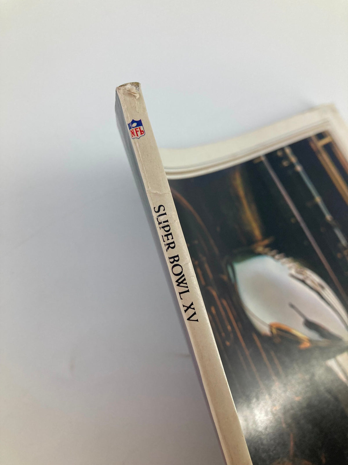 Spine view of the January 25, 1981 NFL AFC vs NFC Super Bowl XV Official Magazine highlighting the title and NFL logo, ideal for collectors.