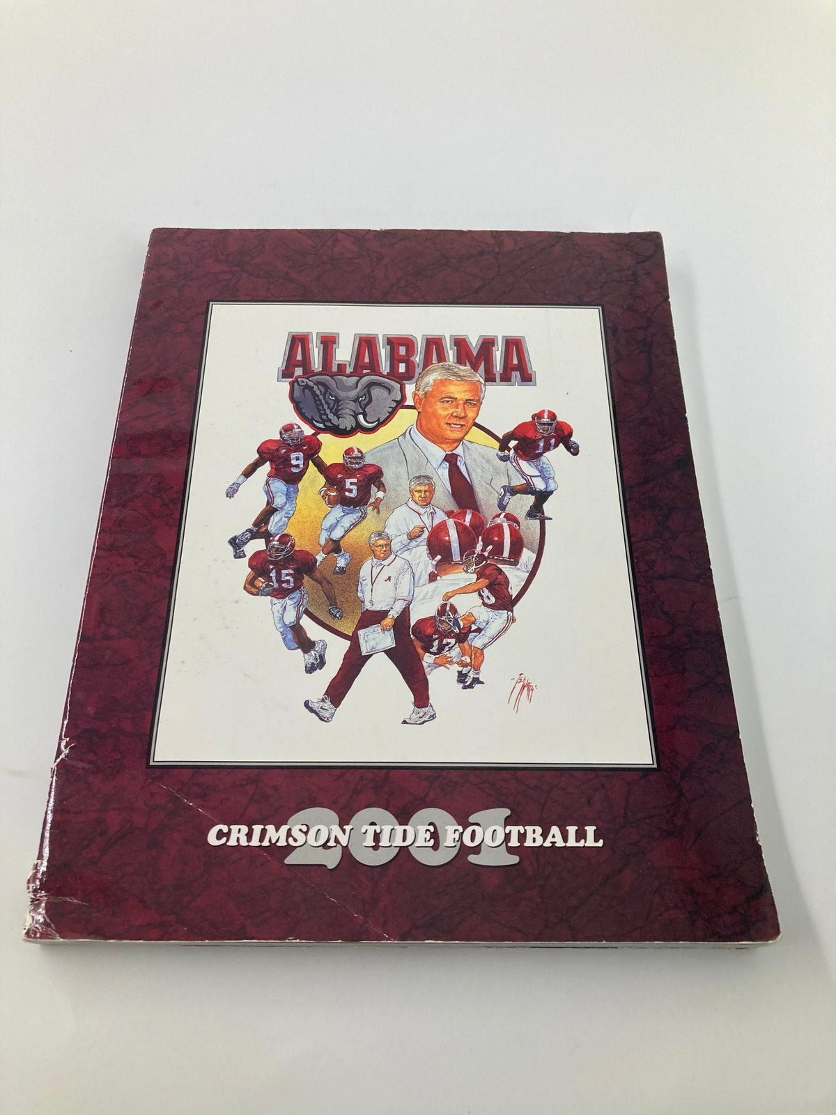 2001 Alabama Crimson Tide Football Official Program cover featuring a collage of players and a coach, showcasing the team's spirit and history.