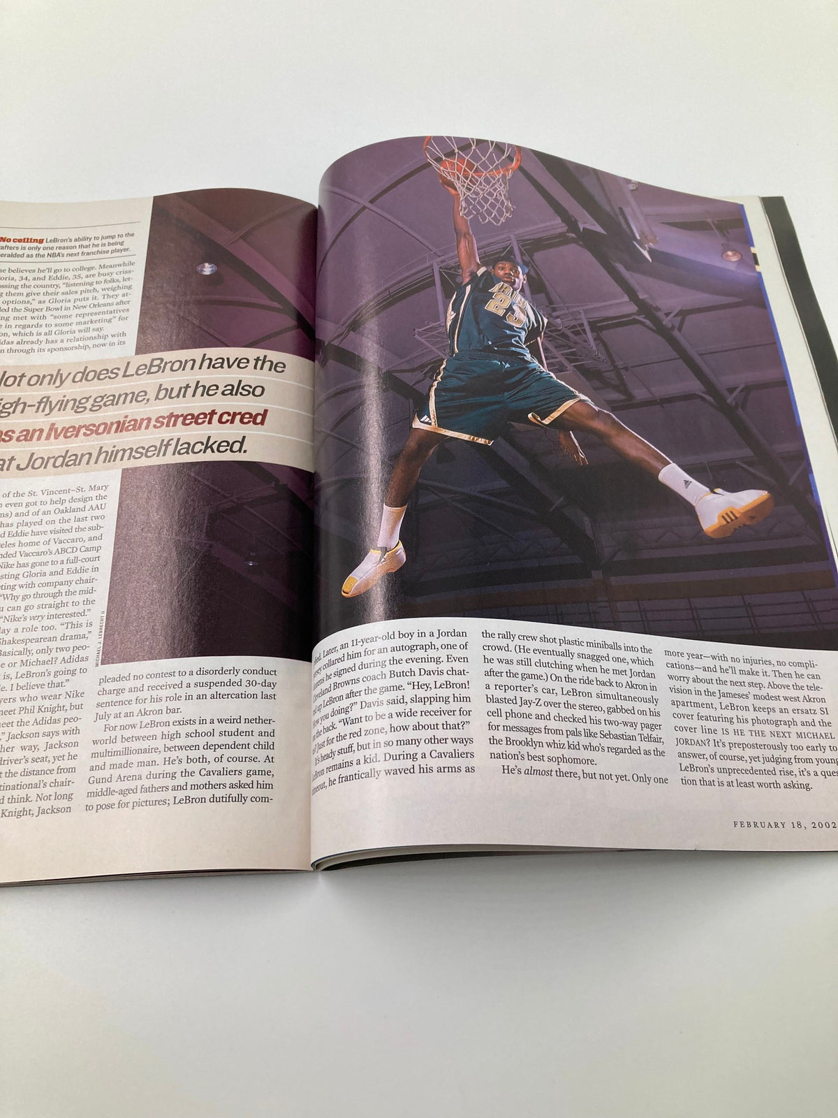 Inside image of Sports Illustrated Magazine August 18 2002 showing LeBron James in action, showcasing his impressive dunking skills and athletic ability.