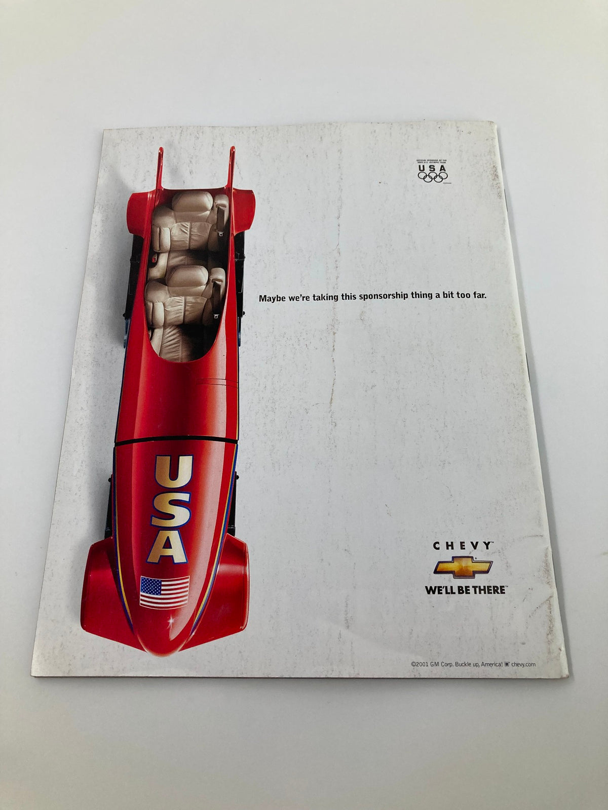 Back cover of Sports Illustrated Magazine August 18 2002 featuring a humorous advertisement with a red racecar and the text regarding sponsorship.