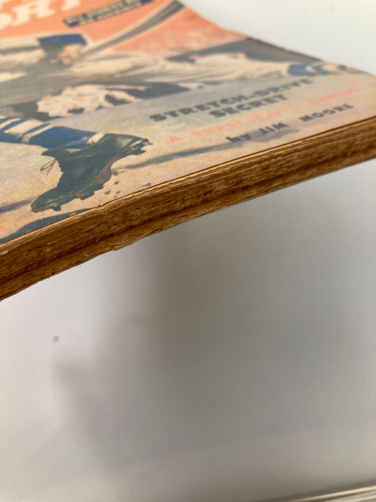 Side view of 'Super Sports' magazine from September 1951, displaying the aged pages and spine, emphasizing its vintage condition.