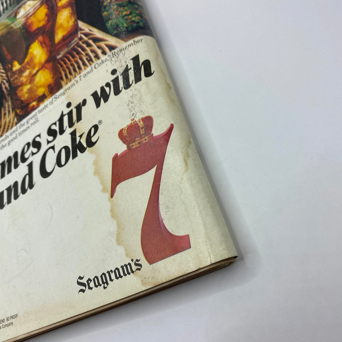 Close-up of Seagram's 7 advertisement in VTG Playboy Magazine December 1982, featuring the iconic red number 7 logo and artistic design.