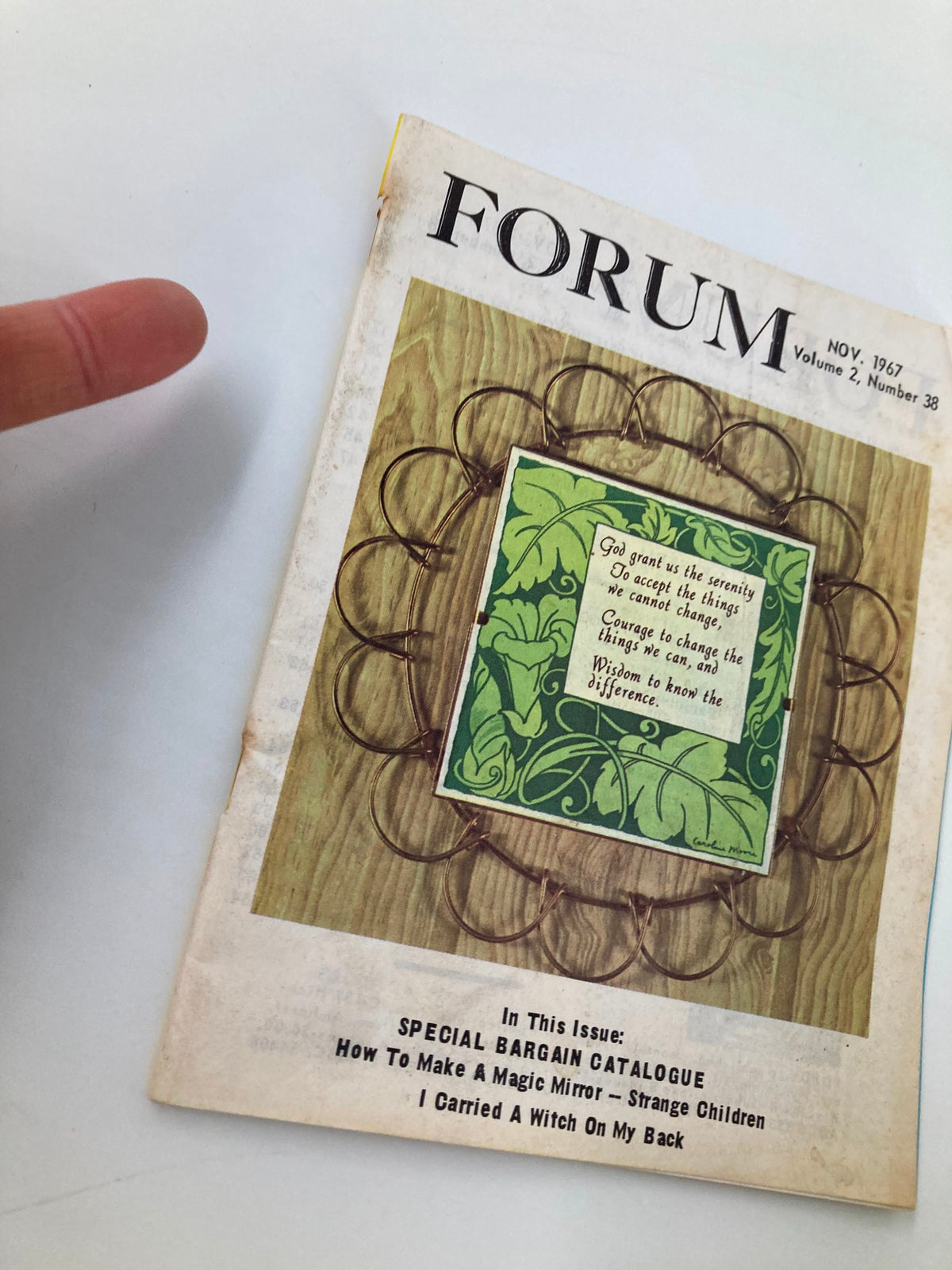 Side view of the VTG Forum Magazine November 1967 Vol 2 #38 with a finger pointing at the cover, showcasing the magazine's condition and unique design.