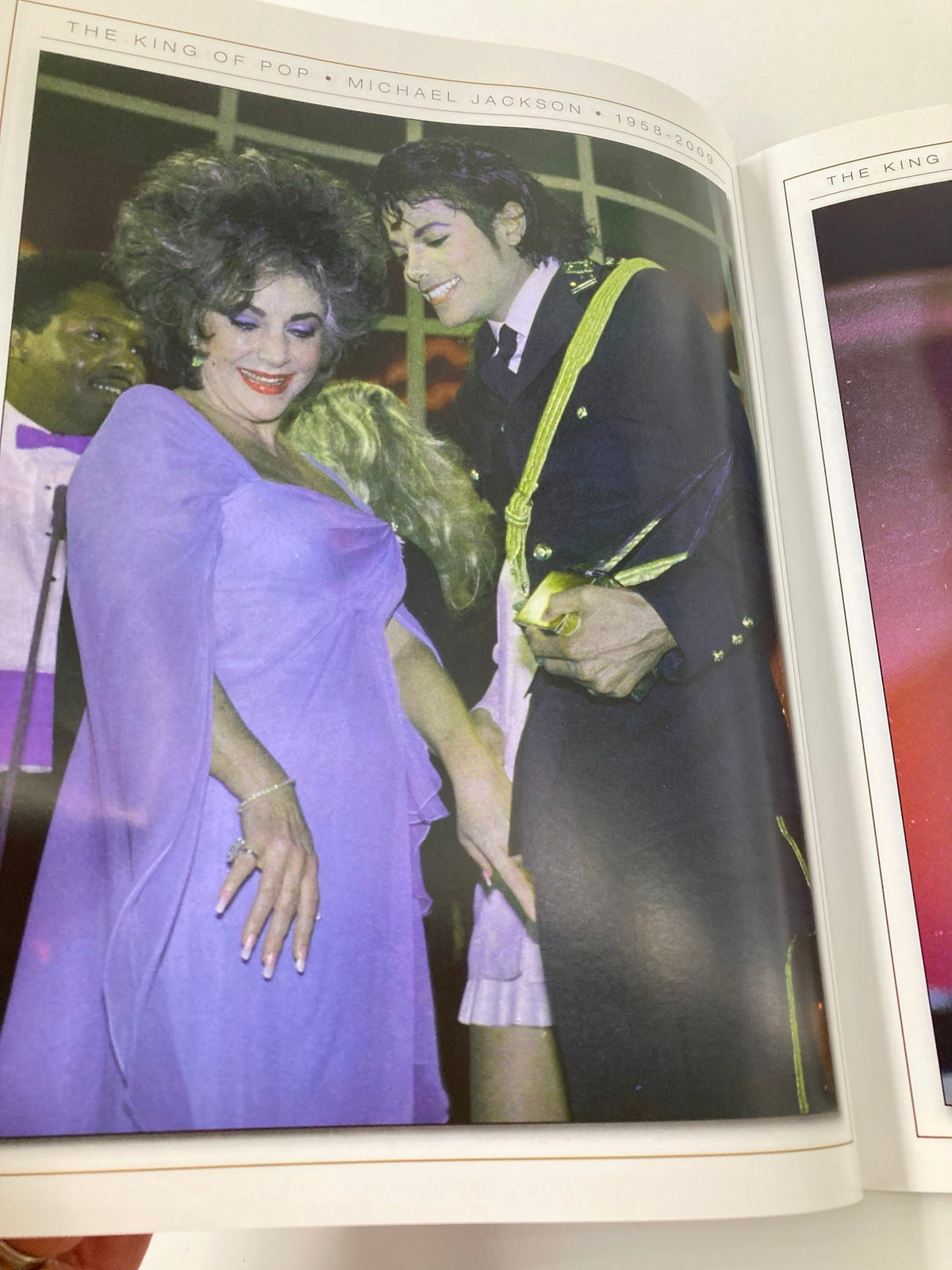 Michael Jackson Collector's Photo Gallery #07 featuring a moment with Elizabeth Taylor at a celebration, highlighting their friendship and iconic status.