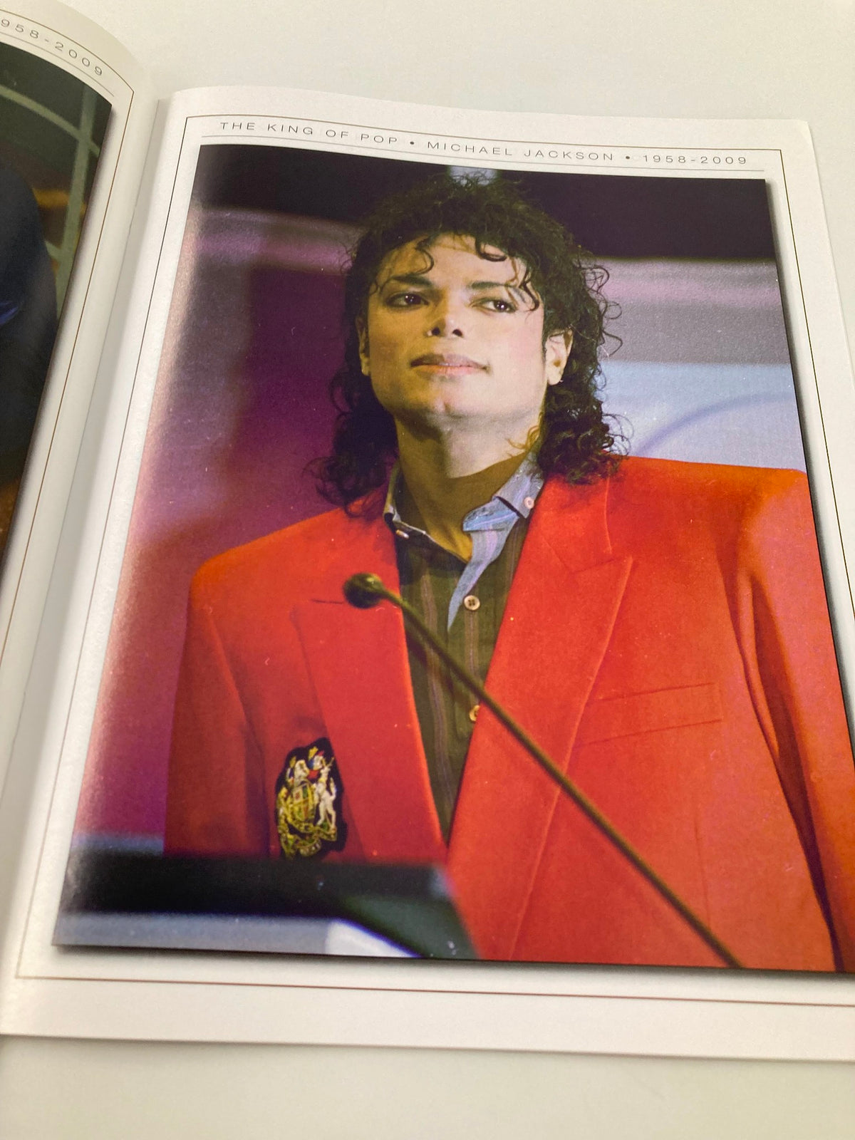 Michael Jackson Collector's Photo Gallery #07 showcasing an iconic portrait of Michael Jackson in a vibrant red blazer, reflecting his unique style and charisma.