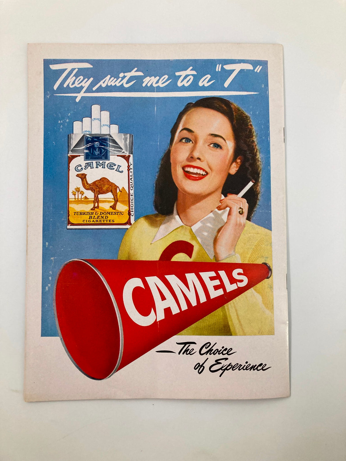 October 18, 1947 Football Official Program displaying a retro Camel cigarette advertisement featuring a cheerful woman, representing the vintage culture of the era.