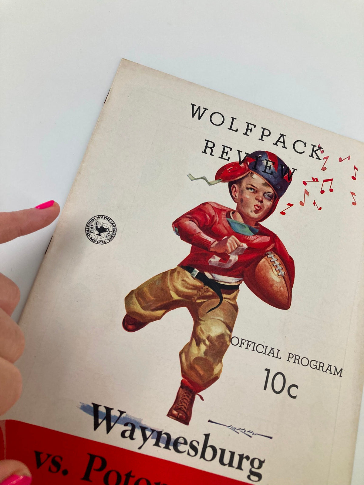 Close-up of the vintage official program for the October 4, 1941 football game between Waynesburg and Potomac State, highlighting the cover design and details.