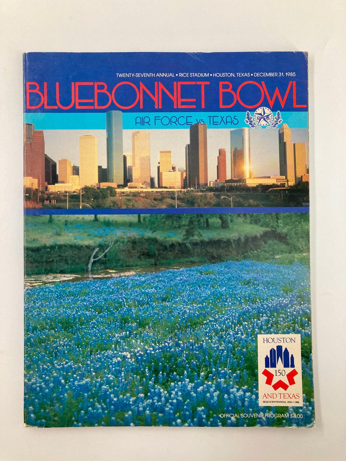 VTG December 31 1985 Bluebonnet Bowl Air Force vs Texas Official Program cover featuring a panoramic view of Houston's skyline and bluebonnet flowers.