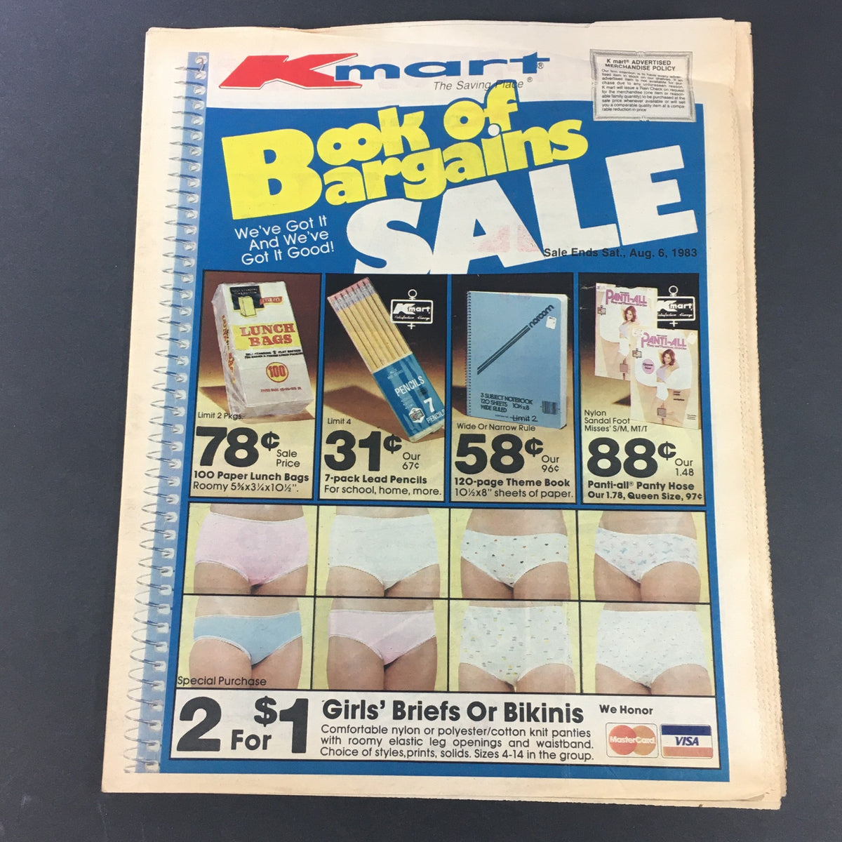 VTG Retro 1983 K-Mart Book of Bargains Sale Circular featuring a colorful cover and advertisements for lunch bags, pencils, panties, and special offers. Sale ends Aug. 6, 1983.