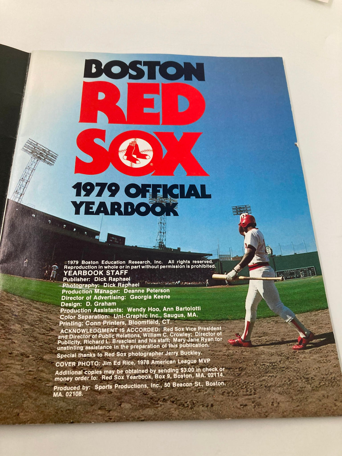 Inside page of the 1979 MLB Boston Red Sox Official Yearbook showcasing the yearbook's editorial staff and players, with a backdrop of Fenway Park.