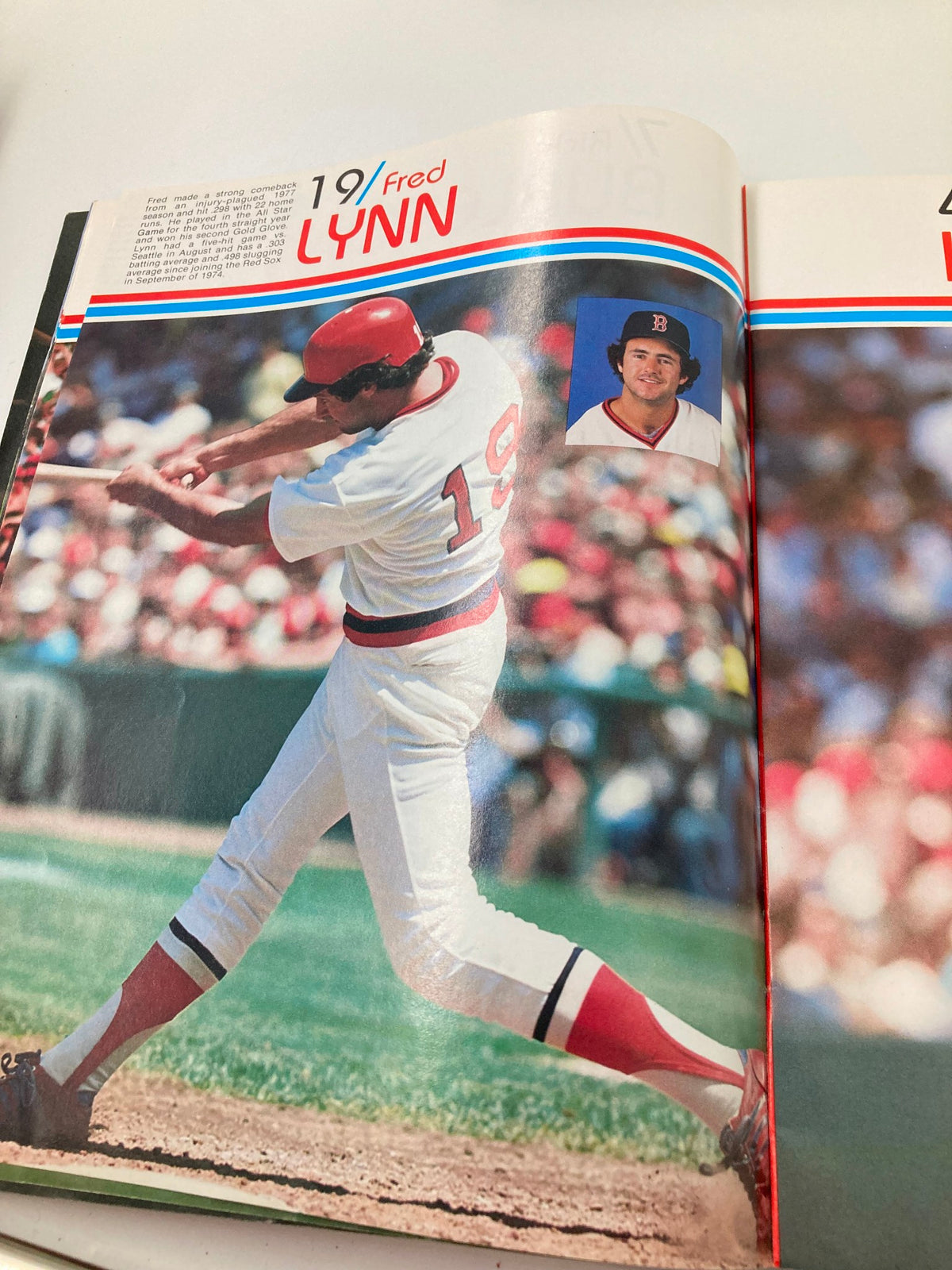 1979 MLB Boston Red Sox Official Yearbook showcasing player Fred Lynn swinging a bat during a game.