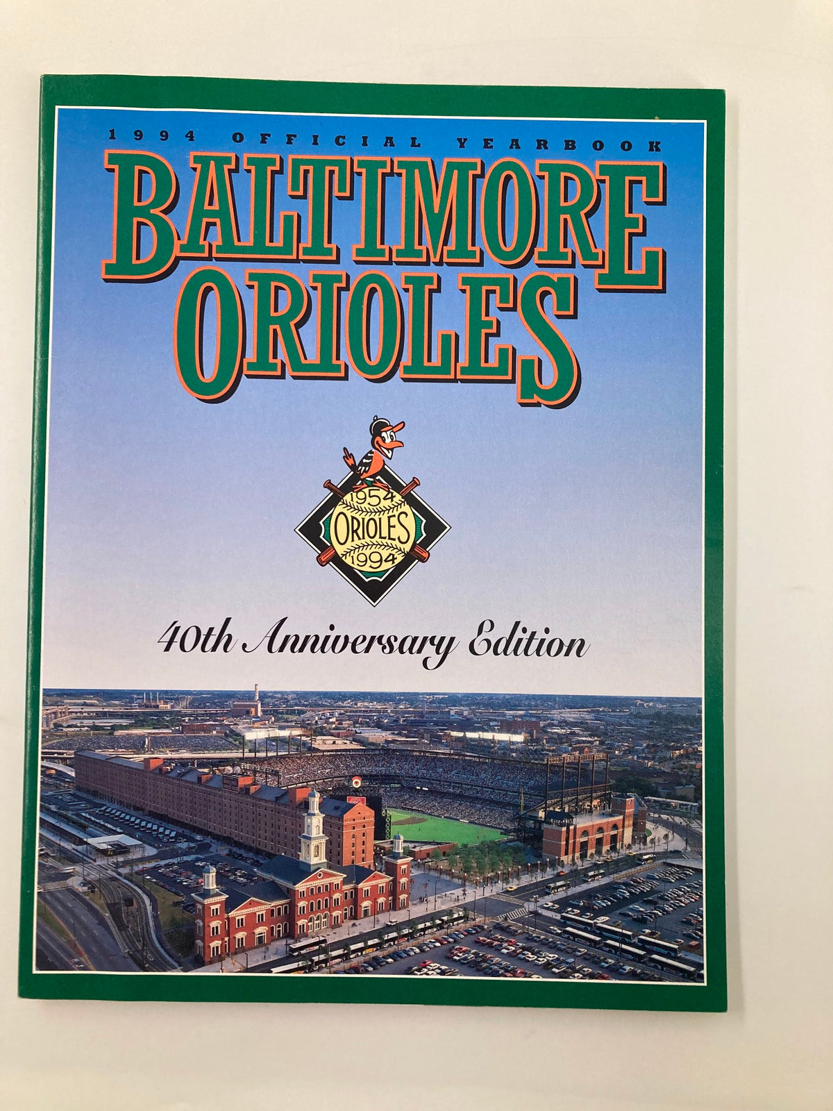 1994 Baltimore Orioles Official Yearbook 40th Anniversary Edition cover featuring an aerial view of Camden Yards and vibrant graphics.