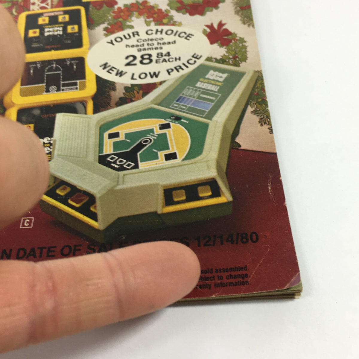 Close-up of the Vintage 1980 Service Merchandise Catalog Showroom Holiday Toy Sale Price Guide showcasing Coleco head-to-head electronic games with sale pricing information.
