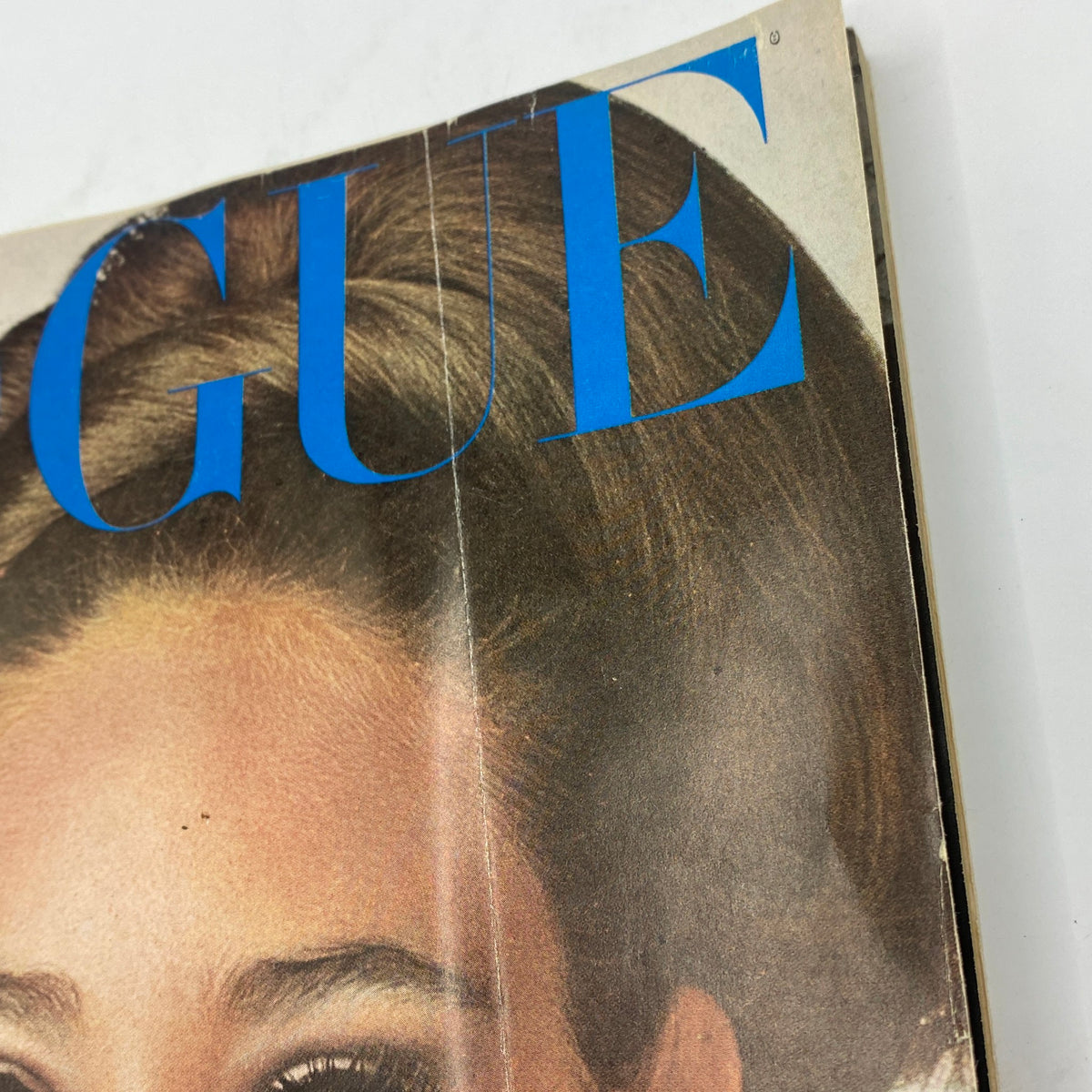 Close-up of the VTG Vogue Magazine October 15, 1965 cover, highlighting the title 'VOGUE' and details of Marisa Berenson's hairstyle.