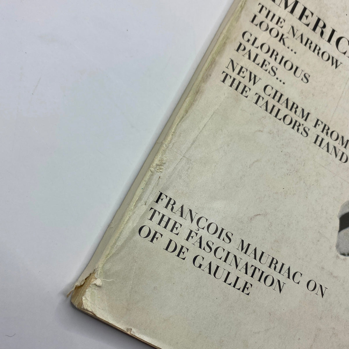 Close-up of the edge of VTG Vogue Magazine September 1 1964 featuring Willhelmina Cooper on the cover, showcasing text related to fashion themes and editorial content.