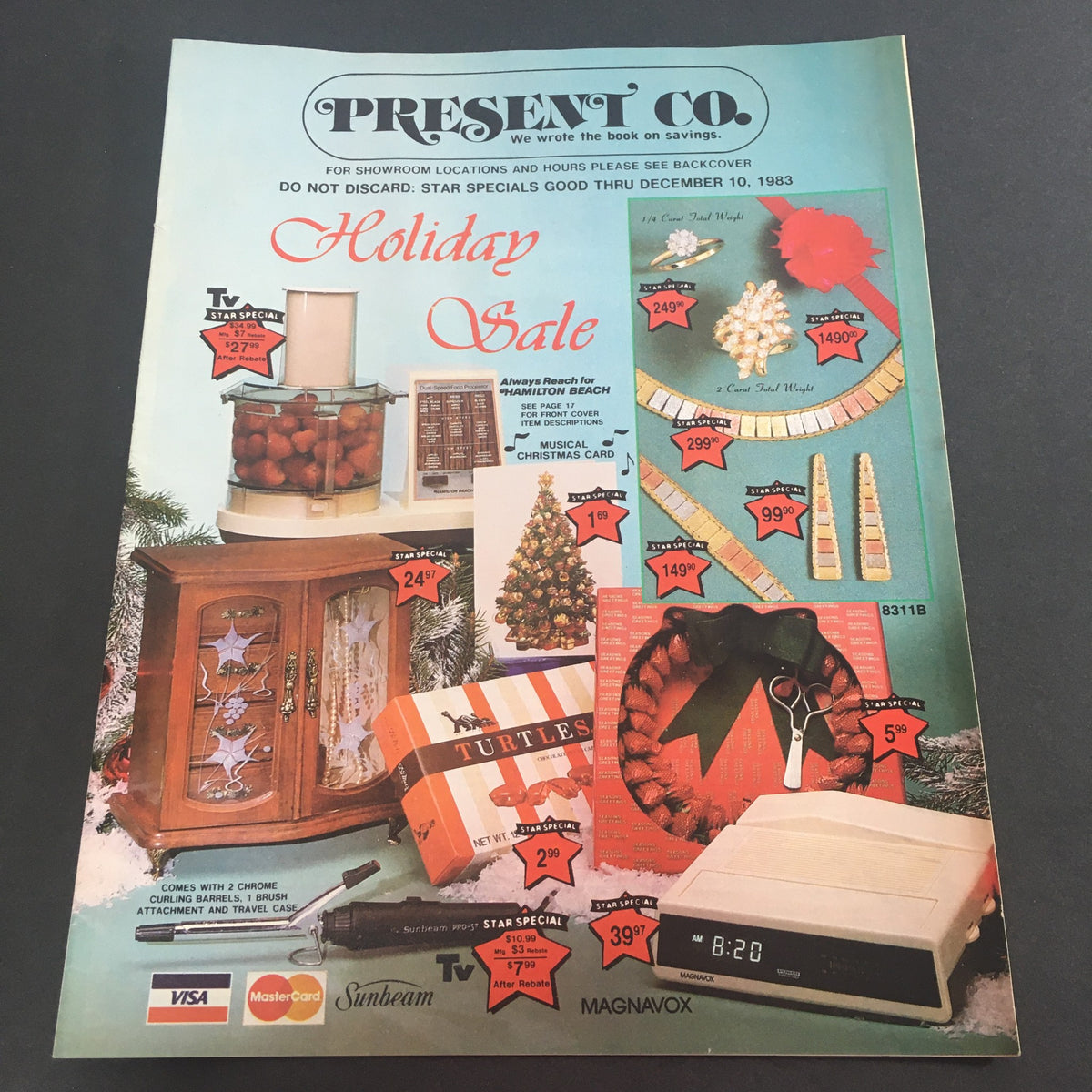 VTG December 1983 Present Co. Holiday Sale Catalog showcasing various holiday sale items including kitchen appliances, decor, and gifts with prices marked. Classic advertising from the 1980s.