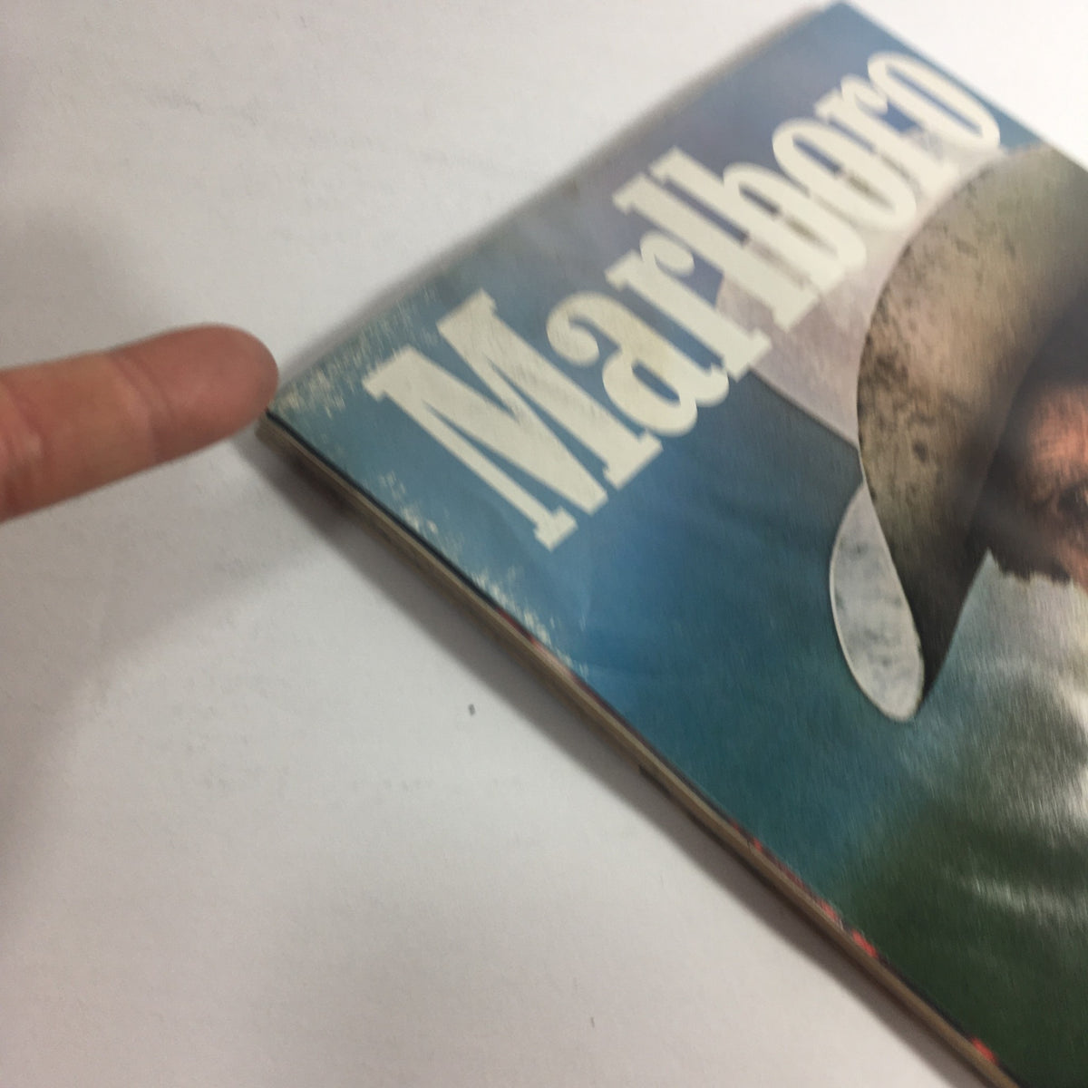 Close-up view of the spine of a vintage Marlboro magazine, highlighting the branding and wear that adds character to this collectible item.