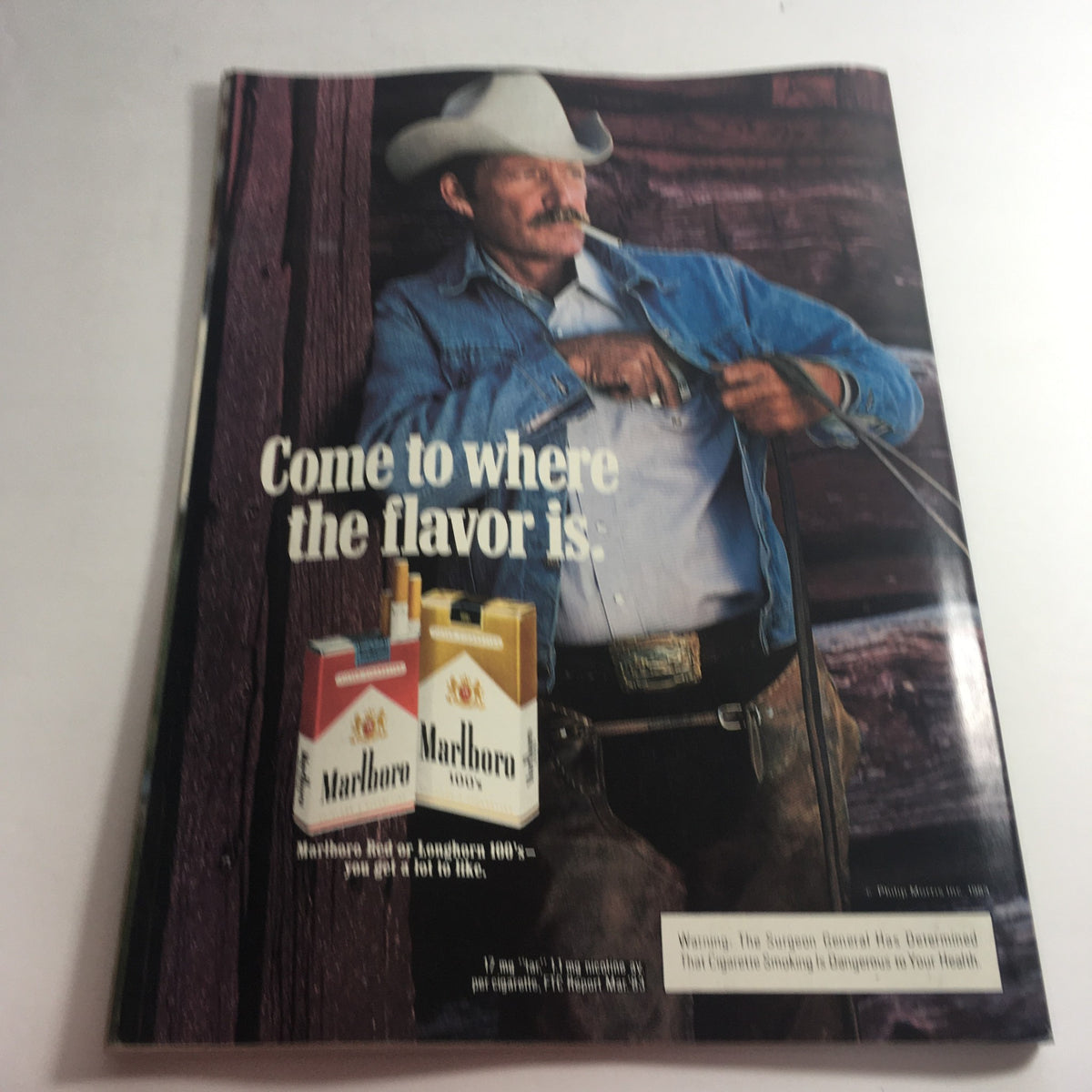 Back cover of the VTG USFL Kickoff Official Magazine 1984 Vol. 2 #4 displaying a vintage advertisement for Marlboro cigarettes featuring a cowboy model. The ad invites viewers to 'Come to where the flavor is'.