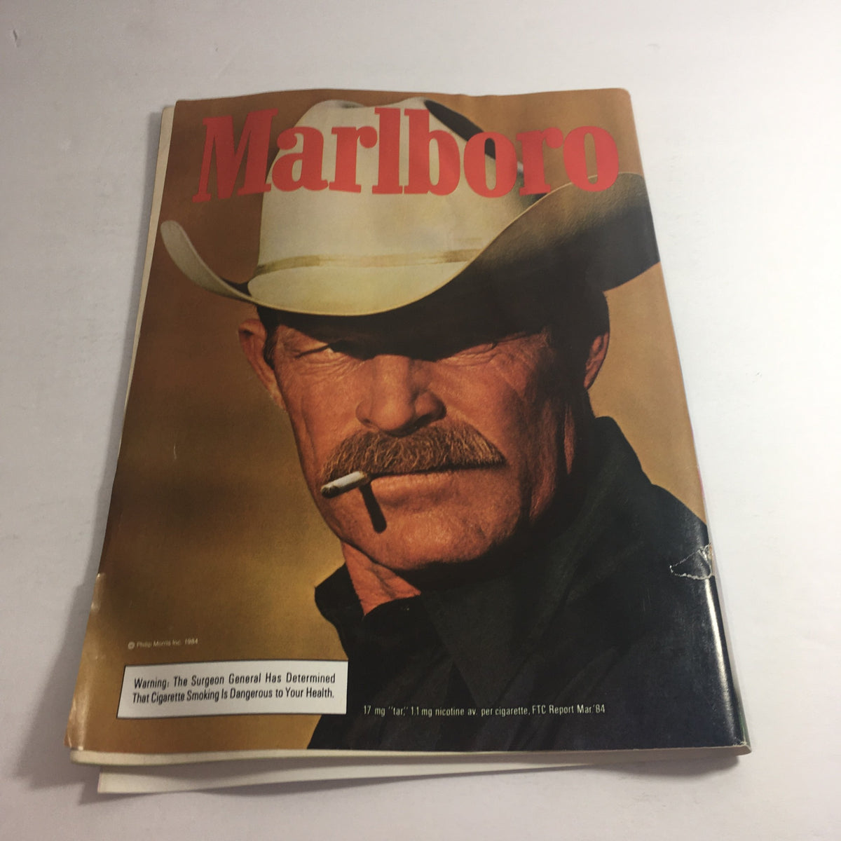 Cover of a vintage Marlboro magazine featuring a cowboy with a cigarette, showcasing the advertising style of the 1980s.
