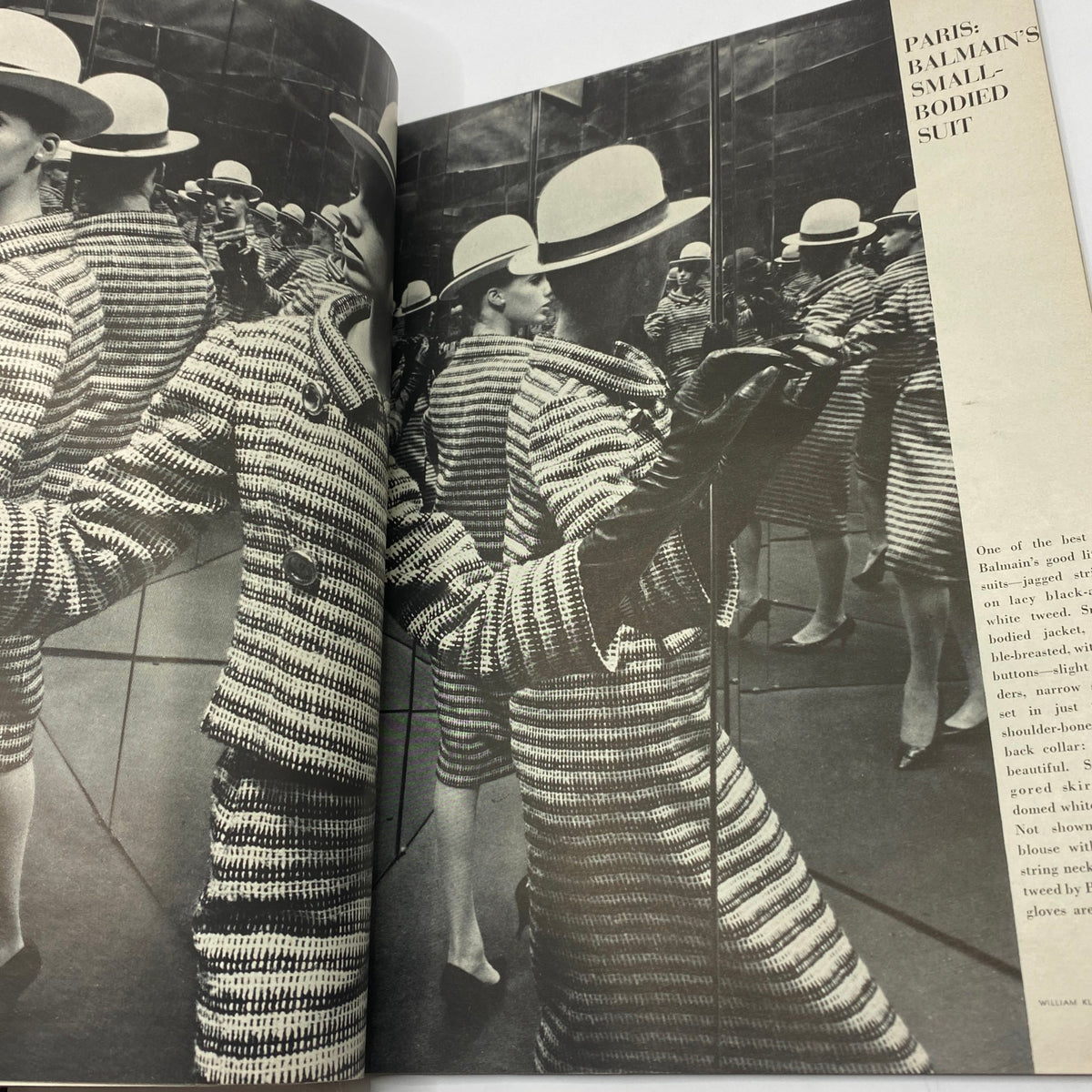 Inside image of the VTG Vogue Magazine March 15 1963 featuring a model in a black and white Balmain suit mirrored in reflective surfaces, photographed by Irving Penn.