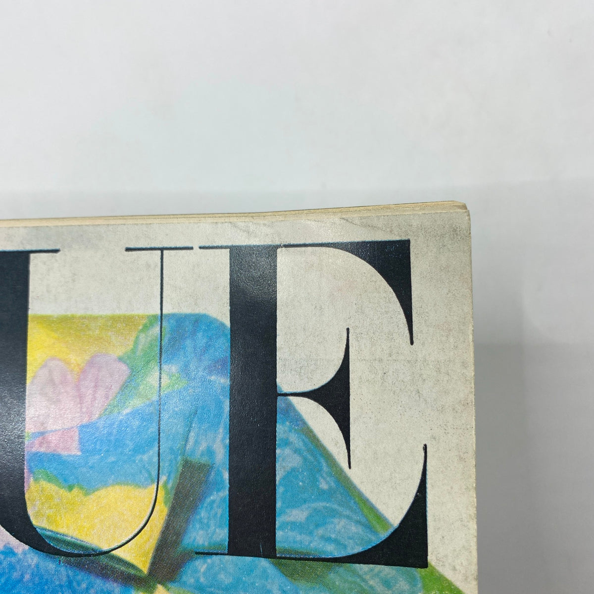 Close-up of the vintage Vogue magazine from February 15, 1964, showcasing the title with artistic design featuring Brigitte Bauer by Irving Penn.
