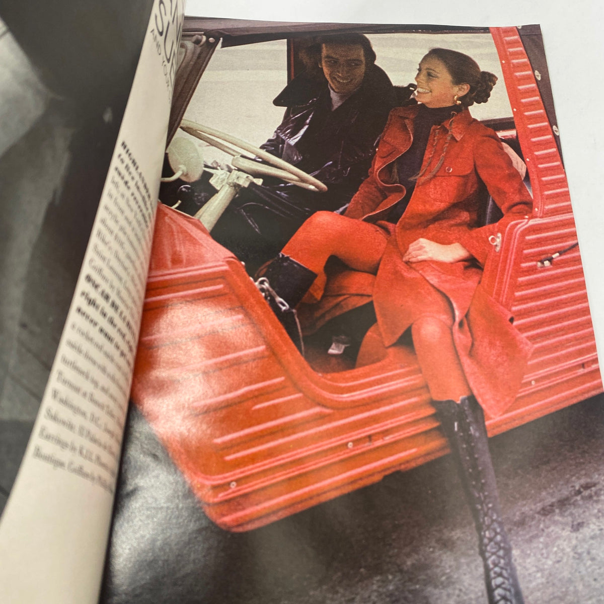 Fashion editorial from VTG Vogue Magazine February 1 1971, featuring models in stylish red outfits inside a vintage car.