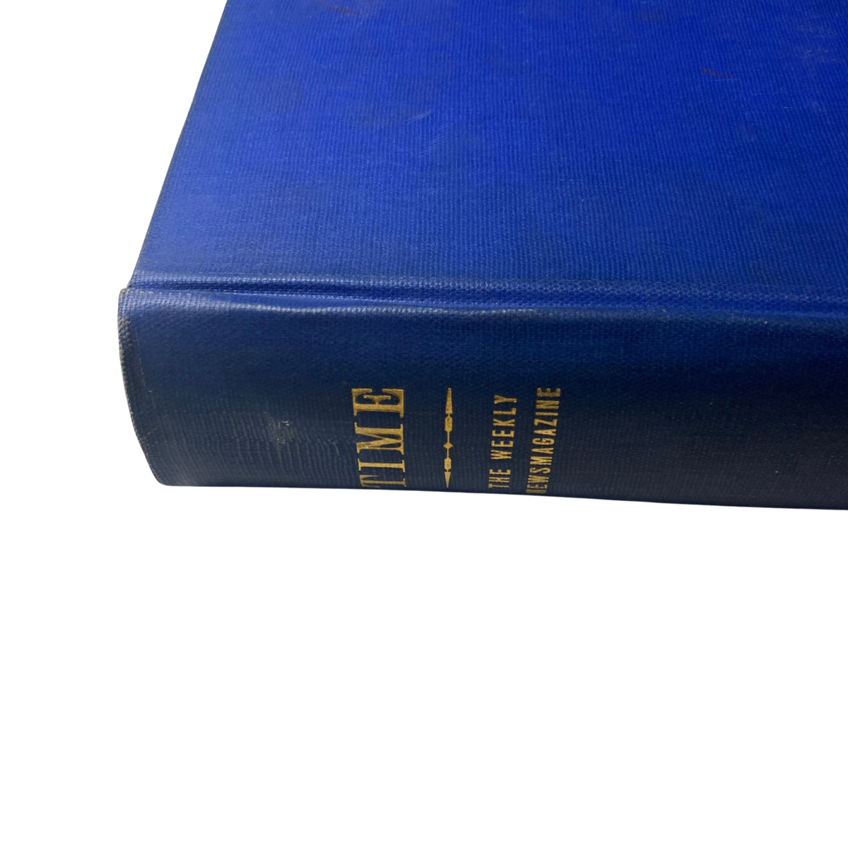 Close-up of the spine of 'Time Magazine Library Bound April 1951 - June 25 1951 Irans Mohammed Mossadeq' featuring blue fabric cover and gold lettering.