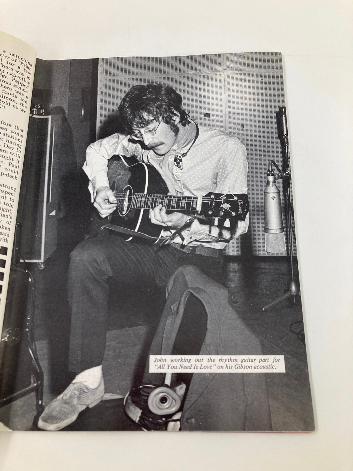 Image of John Lennon playing guitar from The Beatles Book Monthly Magazine June 1987 No. 134, illustrating his creative process for 'All You Need Is Love'.