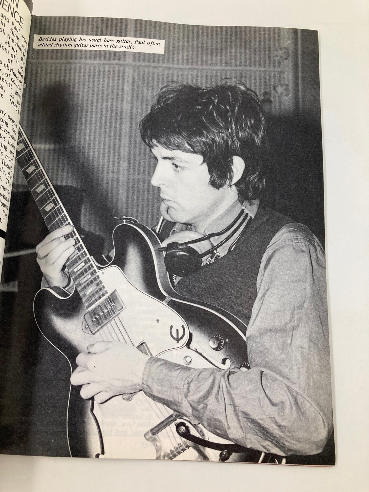 Paul McCartney playing guitar in The Beatles Book Monthly Magazine June 1987 No. 134 - Sgt. Pepper Party, showcasing his role as a musician during the recording sessions.