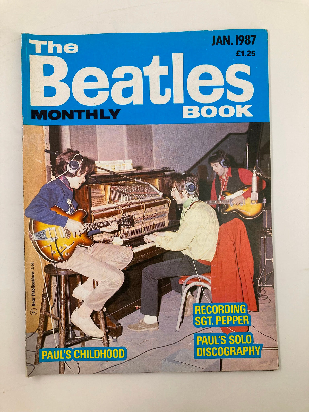 The Beatles Book Monthly Magazine January 1987 #129 featuring an image of Paul McCartney during his childhood, with the title 'Paul's Childhood' highlighted, and additional features listed including 'Recording Sgt. Pepper' and 'Paul's Solo Discography'.