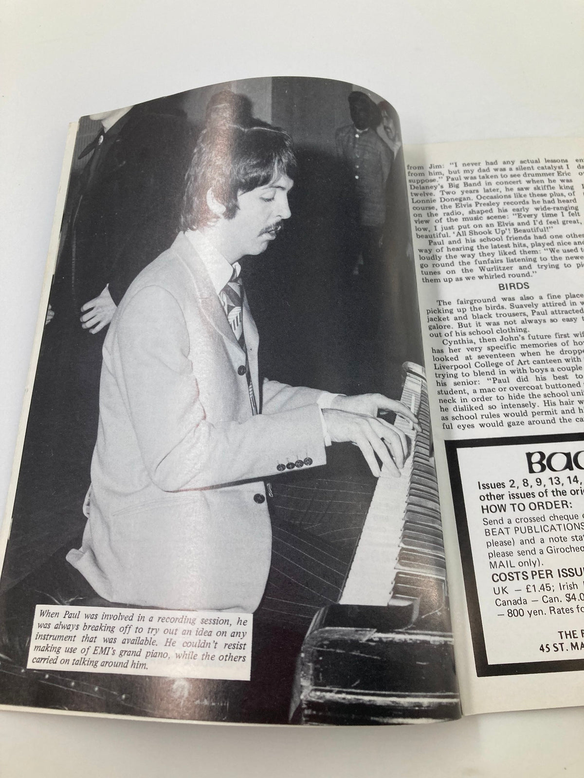 The Beatles Book Monthly Magazine January 1987 #129 Paul's Childhood depicts Paul McCartney focused at a piano during a recording session, illustrating his musical talent and creativity.