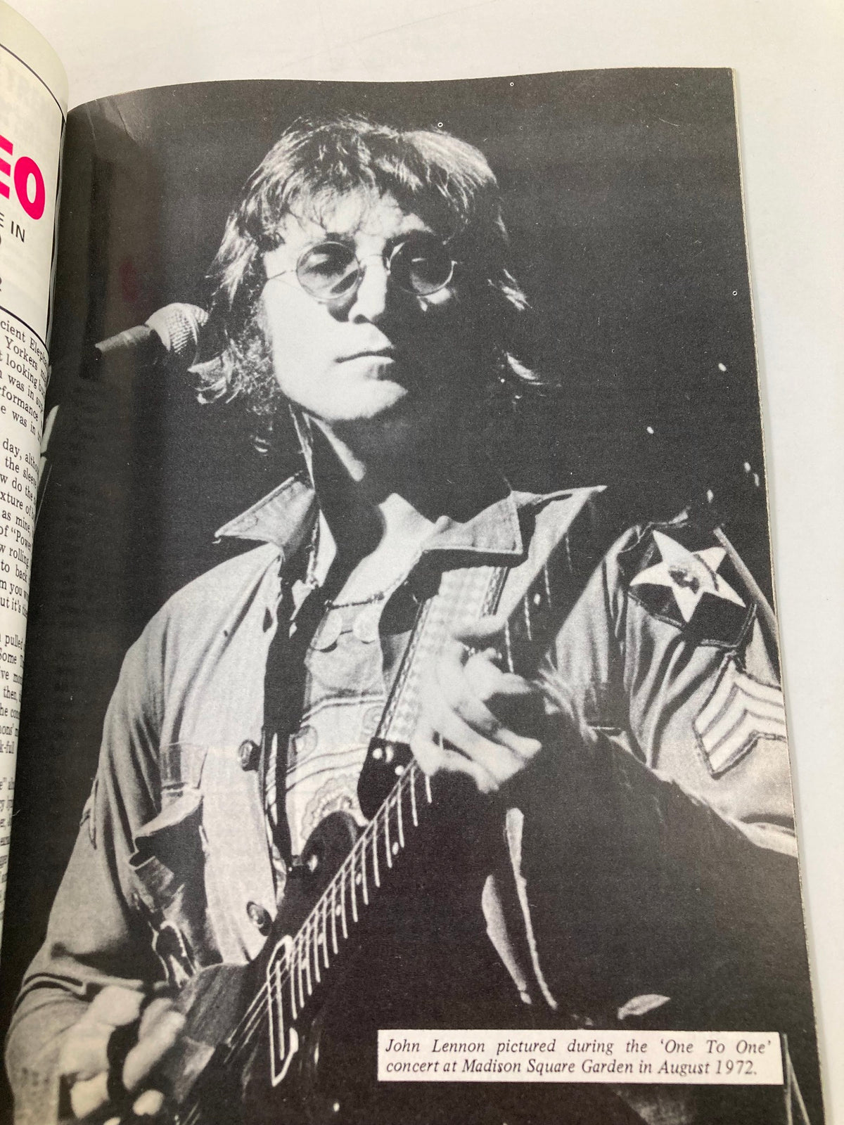 John Lennon performing during the 'One To One' concert at Madison Square Garden in August 1972, as featured in The Beatles Book Monthly Magazine April 1986 #120.