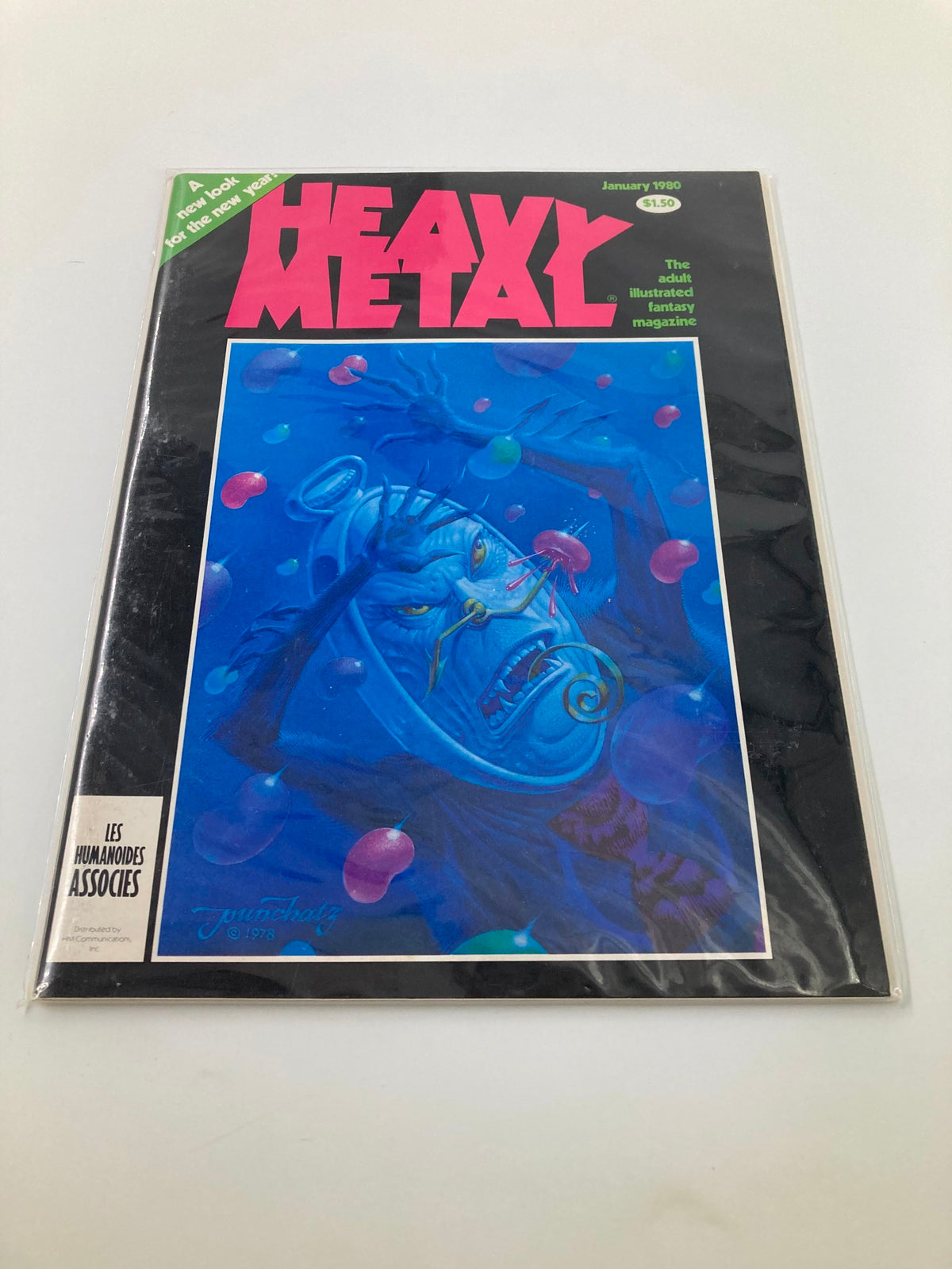 VTG Heavy Metal Magazine January 1980 displayed in protective packaging, illustrating the iconic cover art by Don Ivan Punchatz, perfect for collectors of vintage magazines.