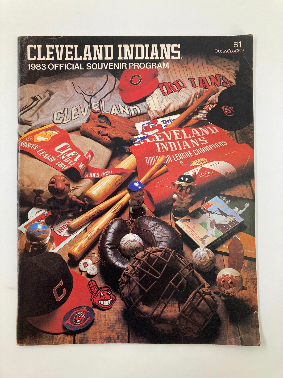 1983 MLB Cleveland Indians vs New York Yankees Official Souvenir Program cover featuring vintage baseball memorabilia such as jerseys, caps, bats, and baseballs, representing a nostalgic piece of sports history.