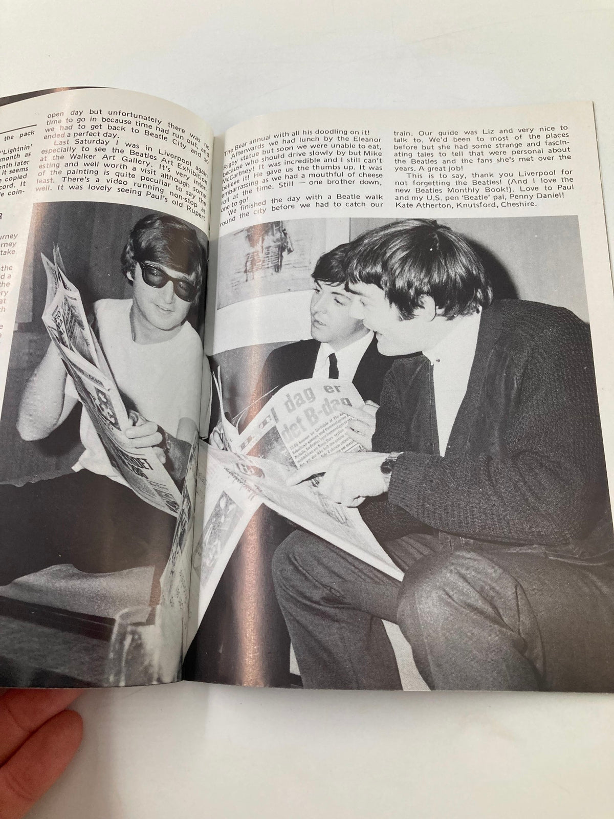 Inside view of The Beatles Book Monthly Magazine July 1984 #99, featuring John Lennon, showing three individuals engrossed in reading. The magazine captures a nostalgic moment of Beatles fandom in the 1980s.