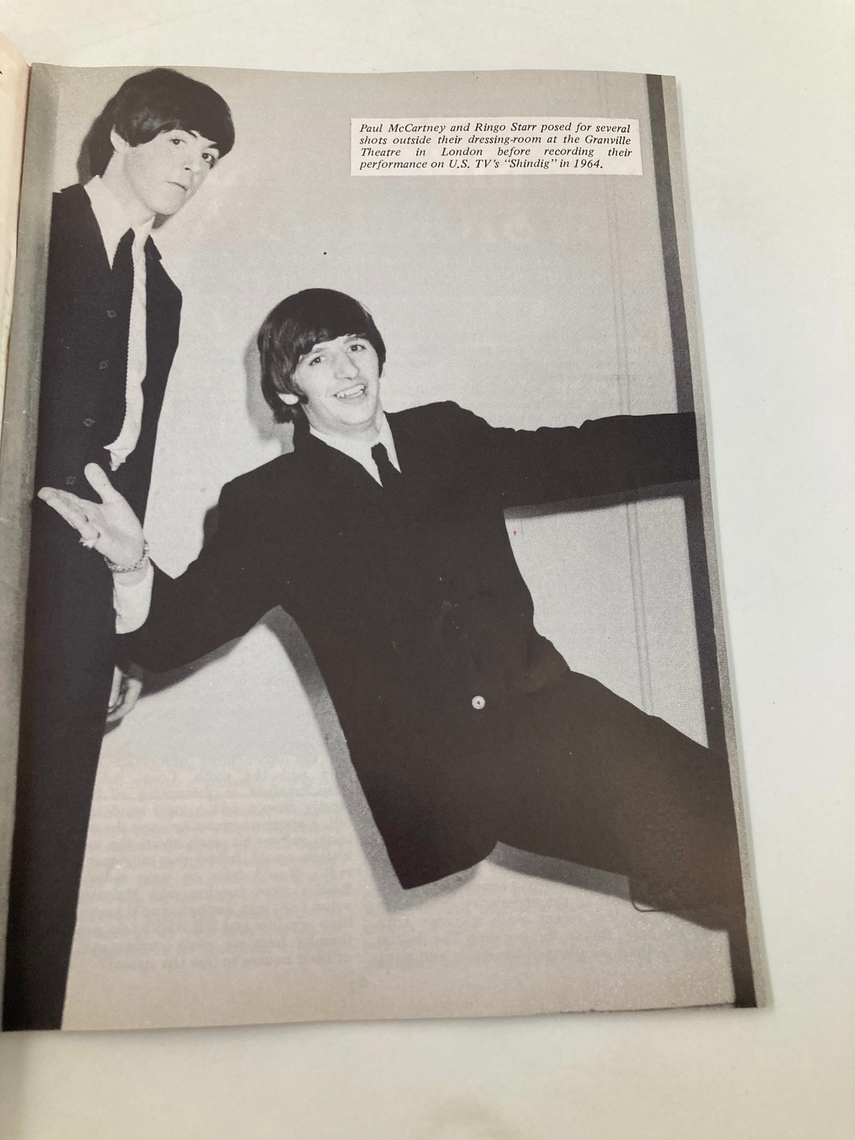 Black and white photo from The Beatles Book Monthly Magazine October 1984 #102 of Paul McCartney and Ringo Starr posing outside their dressing room in London.